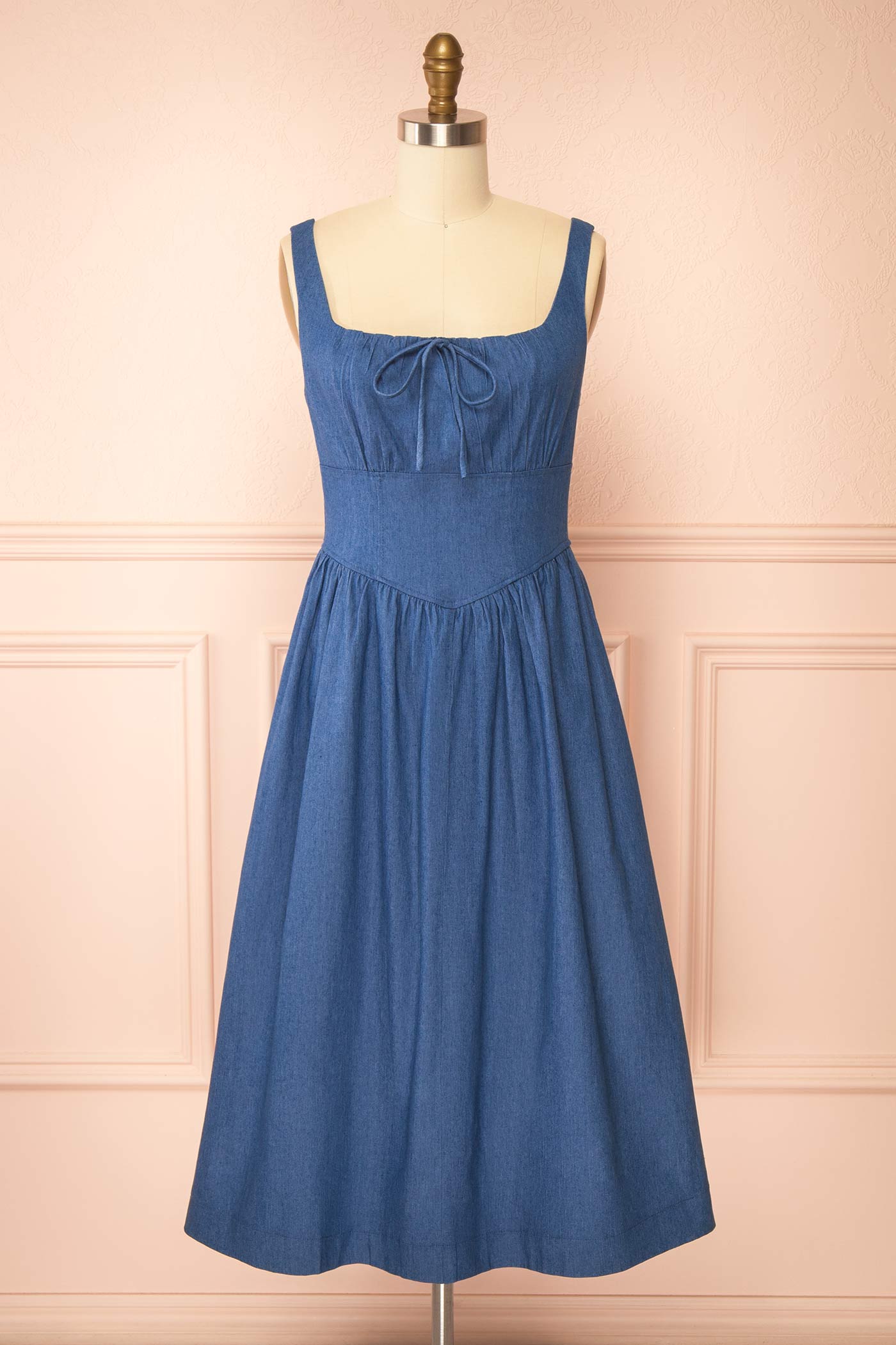 Frontview of Gerogene Blue Denim Midi Dress with Bow and Smocked Back at boutique 1861