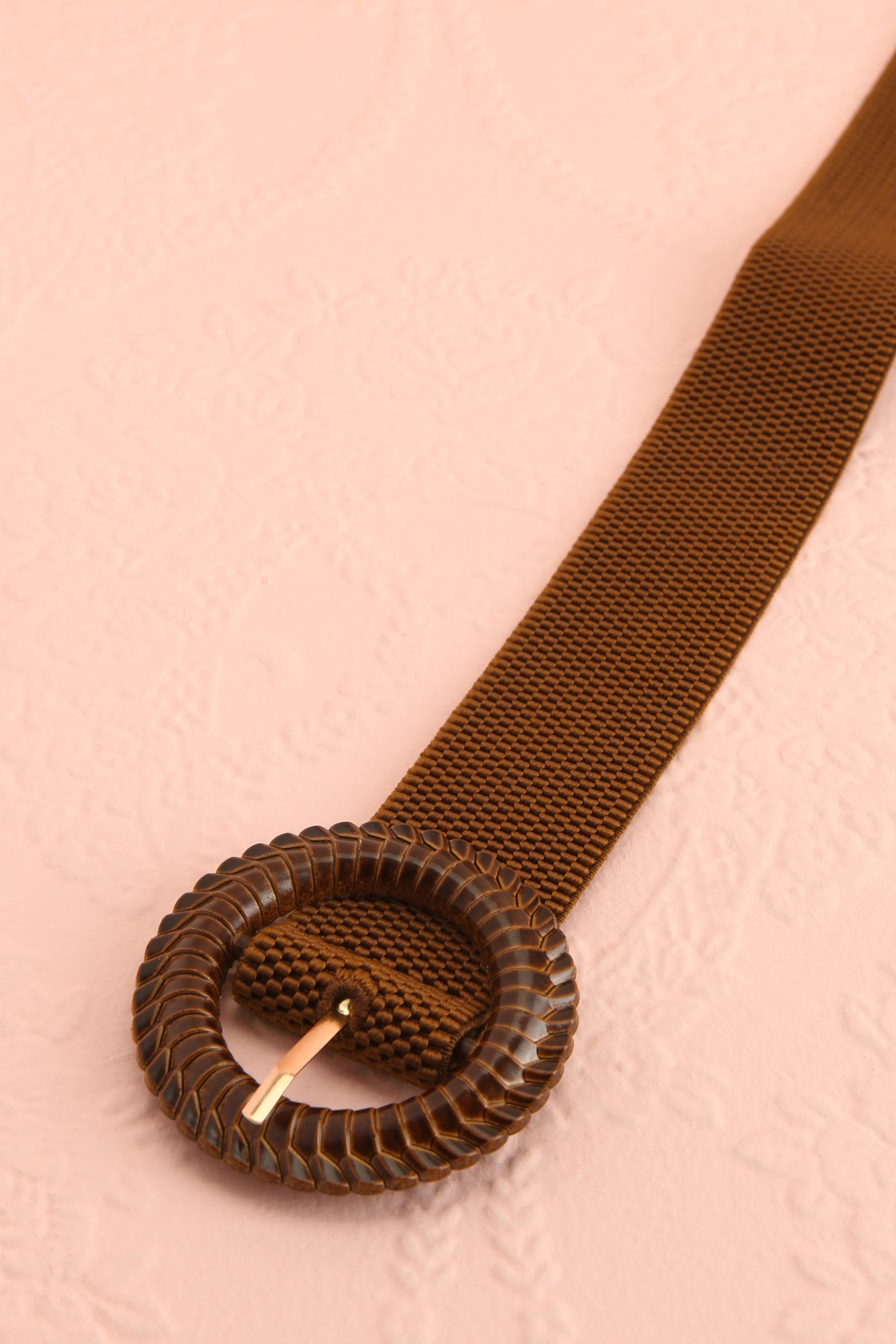 Close-up on mannequin Gumdrop Brown Woven Elastic Belt with Textured Round Buckle at boutique 1861