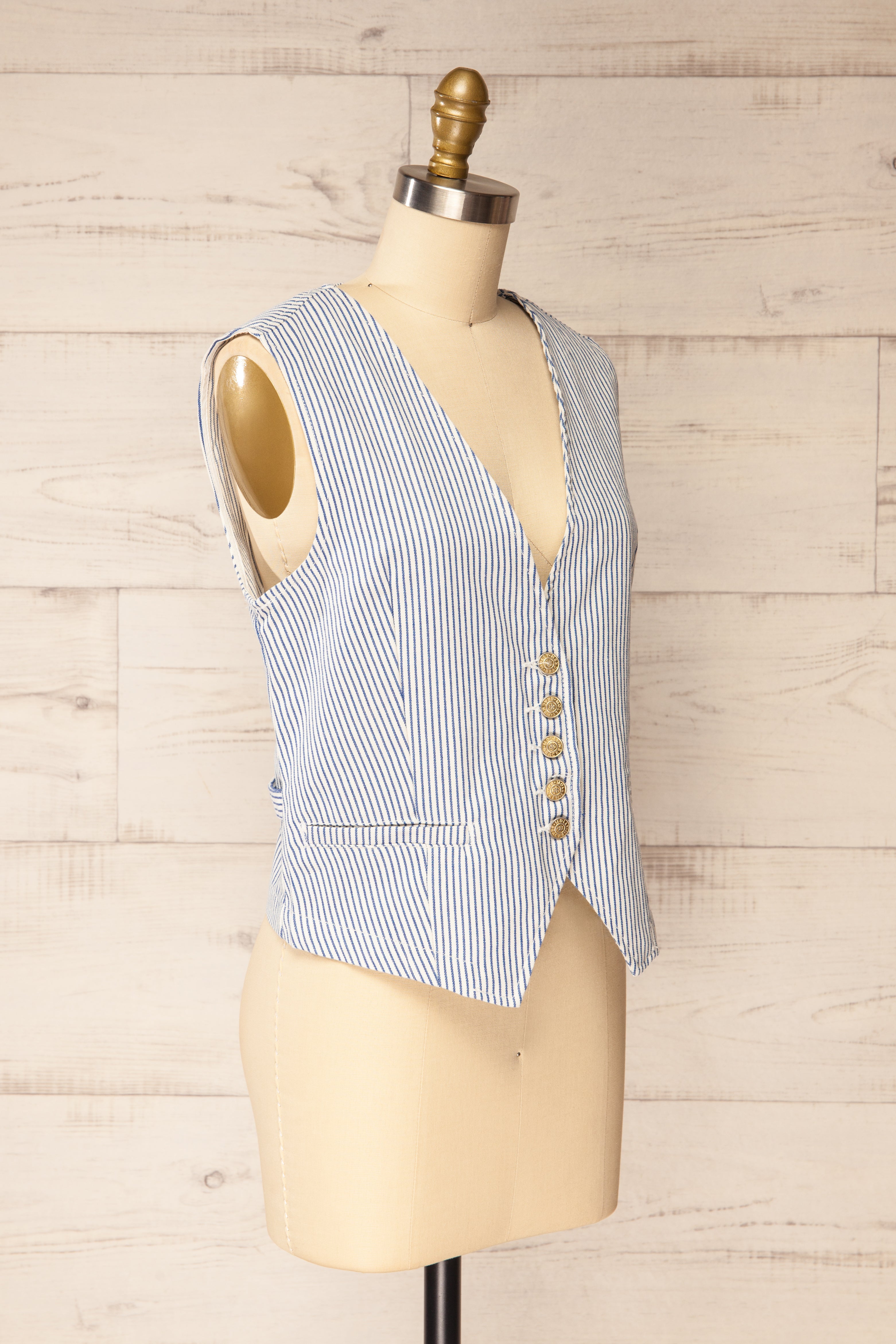 Sideview of Hajipur White and Blue Striped Denim Vest with Back Detail at la petite garçonne