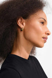 side view of a woman wearing Ignis Gold Small Chunky Hoop Earrings by Pilgrim from La petite garçonne