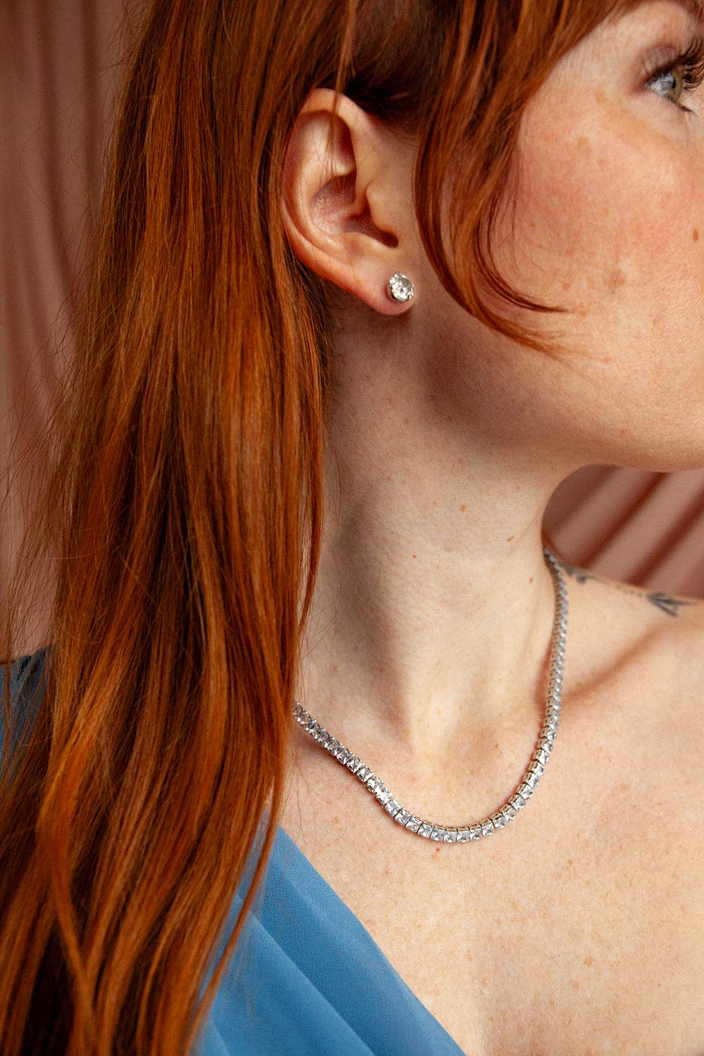 woman wearing a Cubic Crystal Linked earrings and a matching necklace called Jawad from boutique 1861.