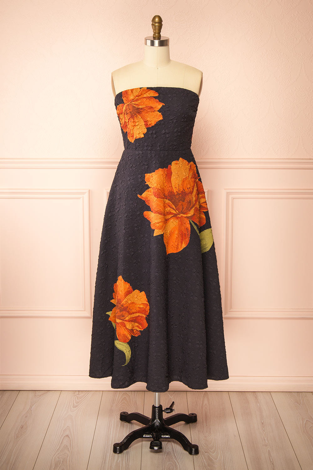 front view of a Mannequin wearing the Kerina Midi Floral Strapless Dress from boutique 1861