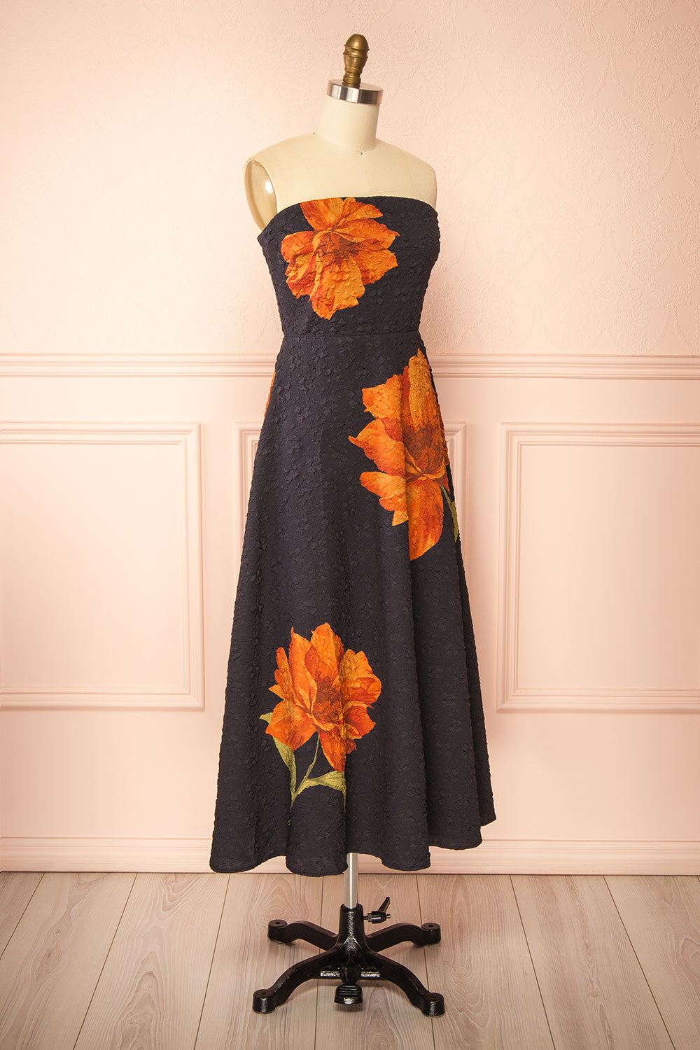 side view of a Mannequin wearing the Kerina Midi Floral Strapless Dress from boutique 1861