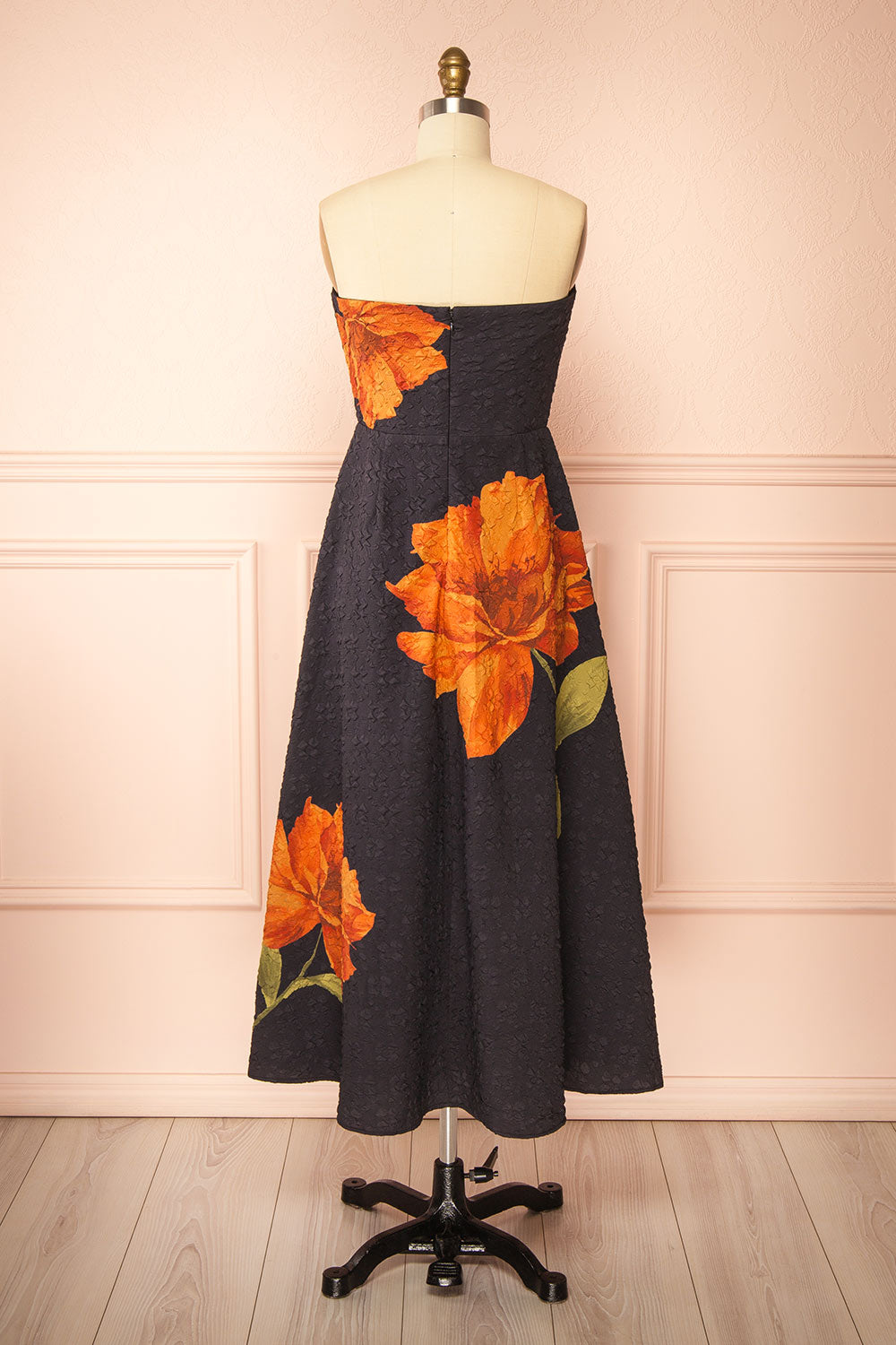 back view of a Mannequin wearing the Kerina Midi Floral Strapless Dress from boutique 1861