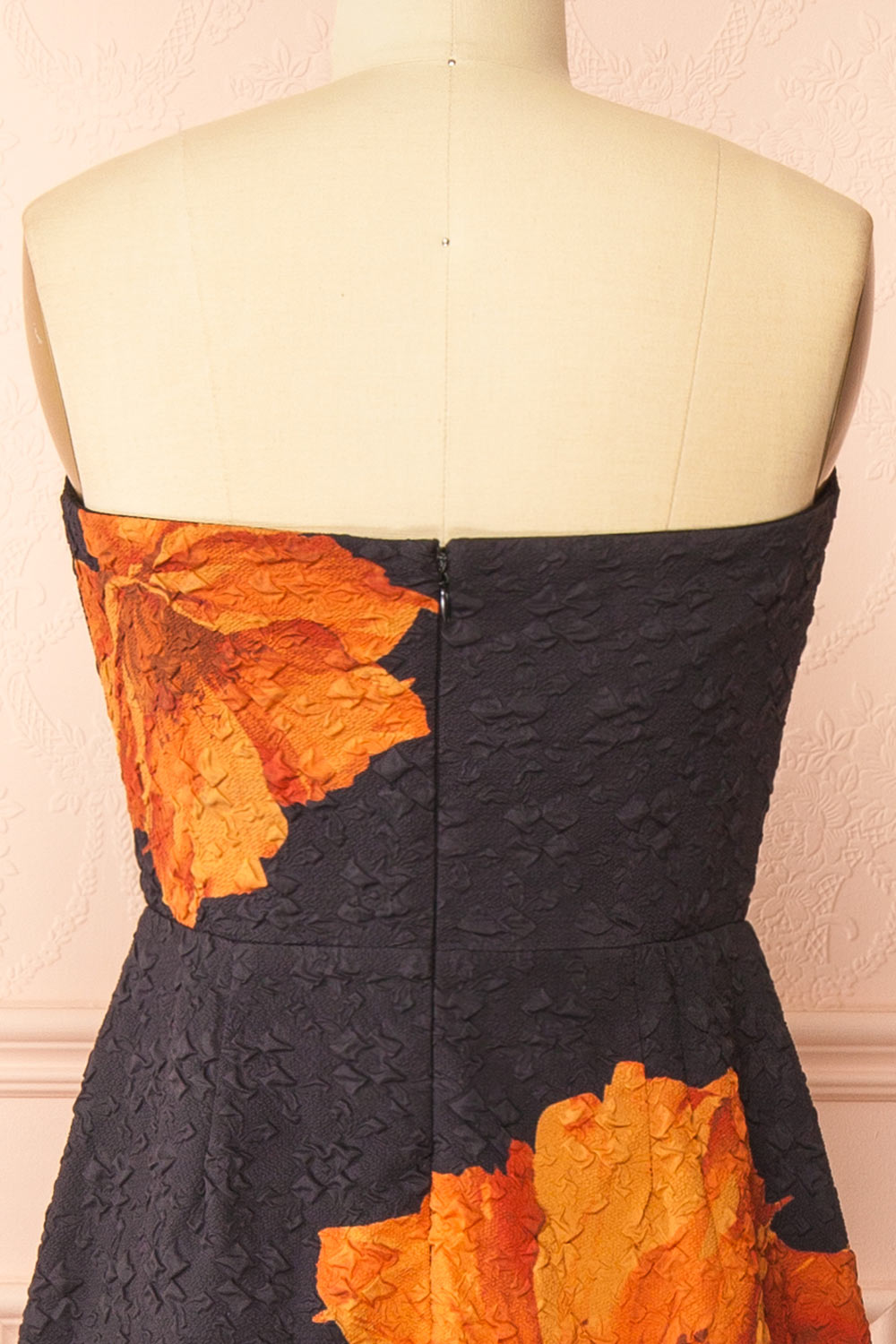 back of a Mannequin wearing the Kerina Midi Floral Strapless Dress from boutique 1861