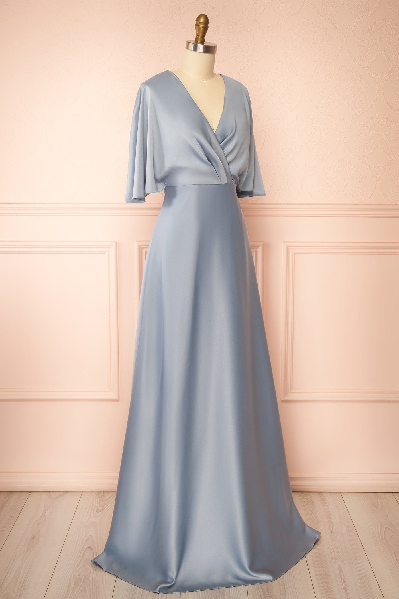 Sideview of Marinella Blue Satin Maxi Dress with Bell Sleeves at boutique 1861