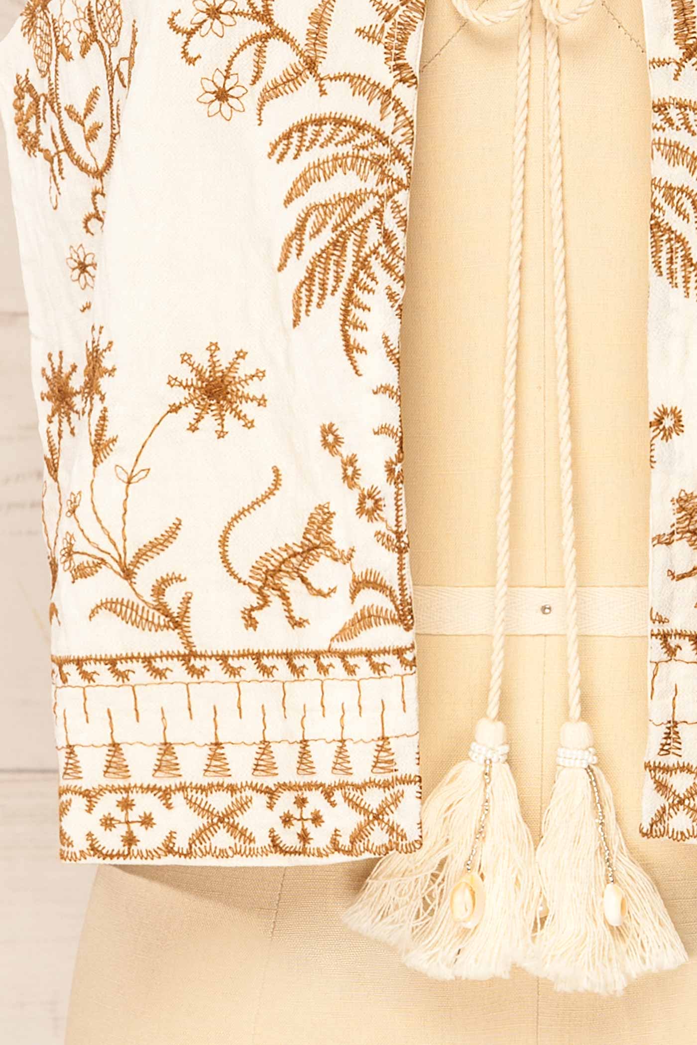 Close-up Nabha Embroidered Boho Tie-Front Ivory Top with Tassels at la petite garçonne