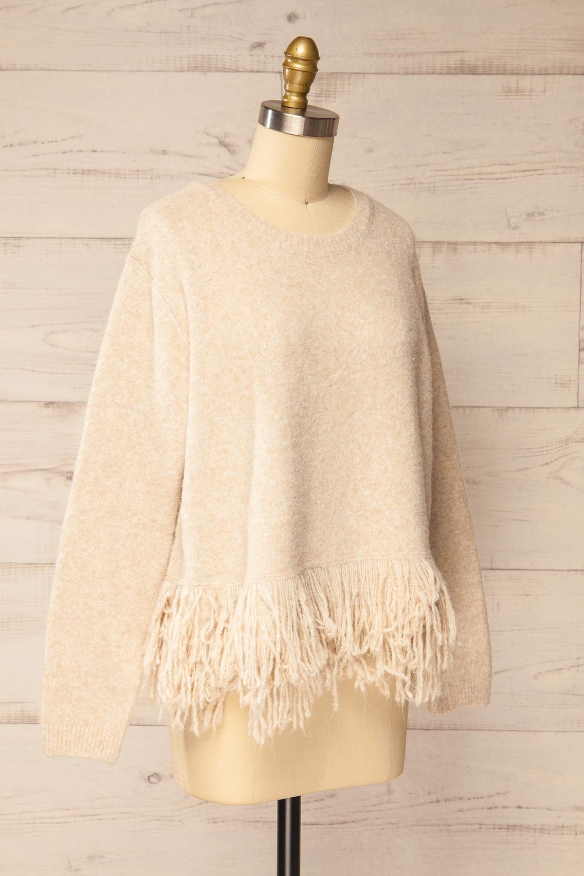 side view of Nachvak Beige Fringe Hem Crew Neck Knit Sweater at La petite garçonne