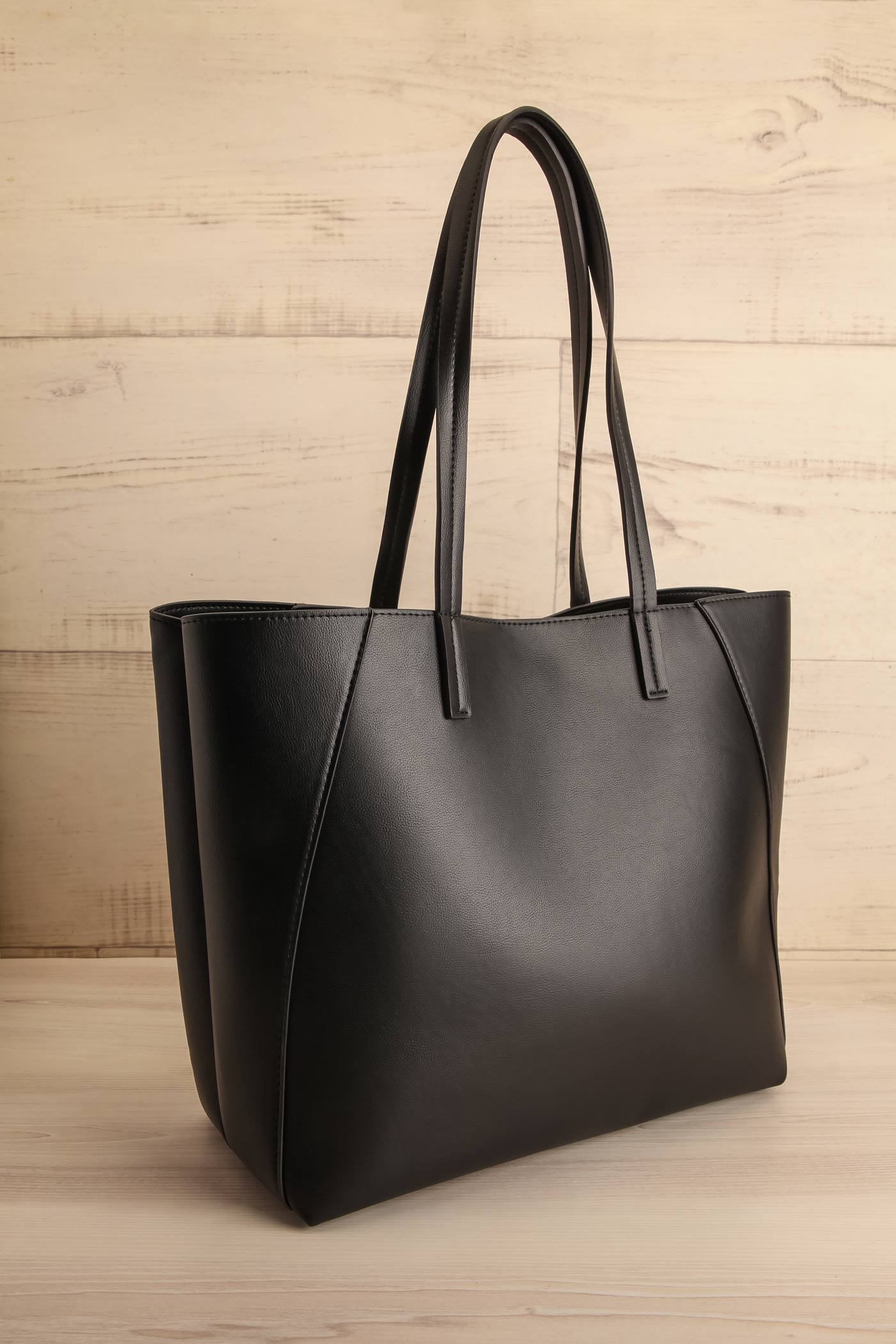 side view of Nanika Black Faux-Leather Tote Bag at La petite garçonne
