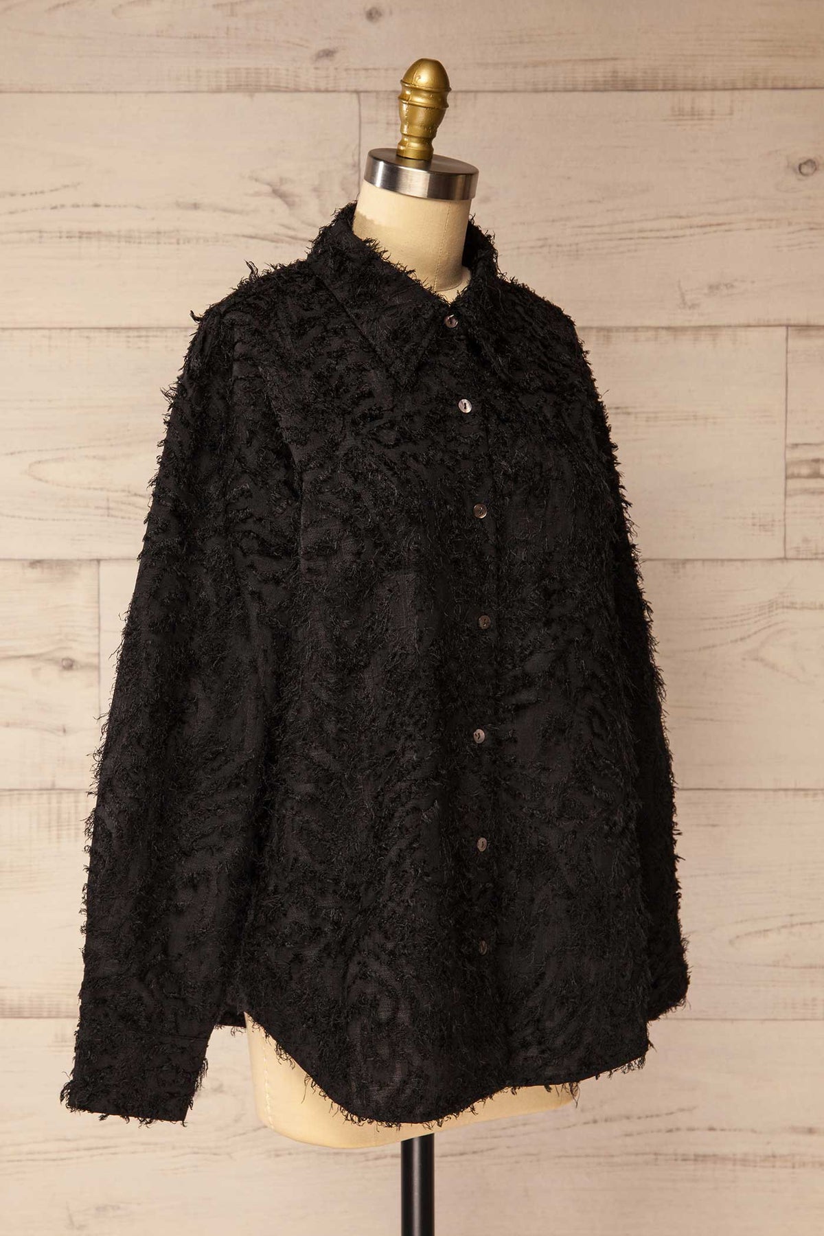 side view of Ostrovnoye Black Textured Fringe Long Sleeve Button-Down Shirt at La petite garçonne