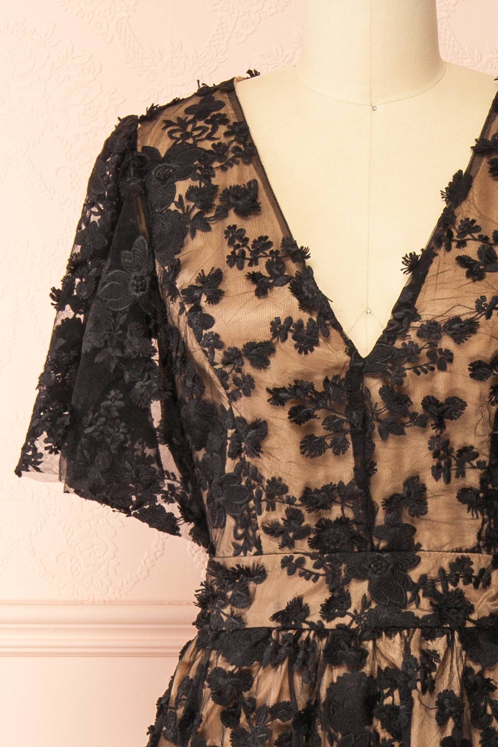 front of a Mannequin wearing the Oukie Black Midi Floral Lace Dress from boutique 1861