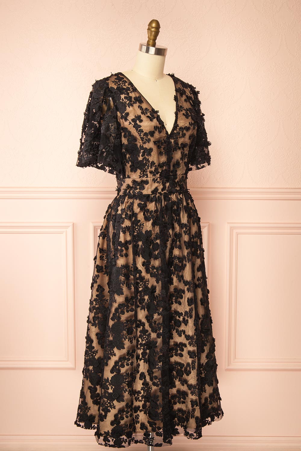 side view of a Mannequin wearing the Oukie Black Midi Floral Lace Dress from boutique 1861