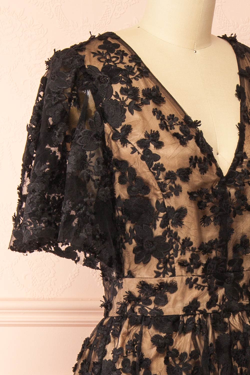 side of a Mannequin wearing the Oukie Black Midi Floral Lace Dress from boutique 1861