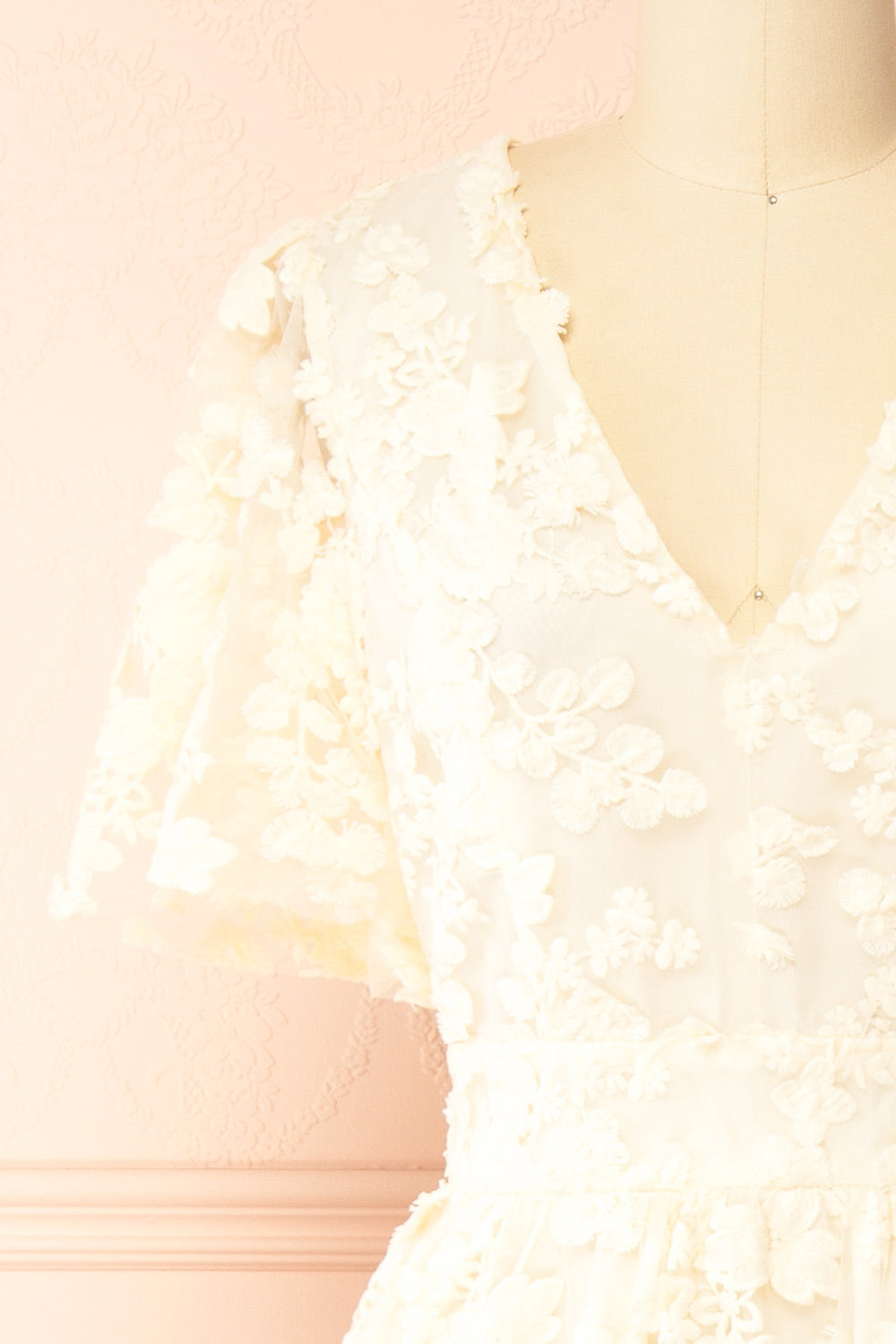 front of a Mannequin wearing the Oukie Ivory Midi Floral Lace Dress from boutique 1861