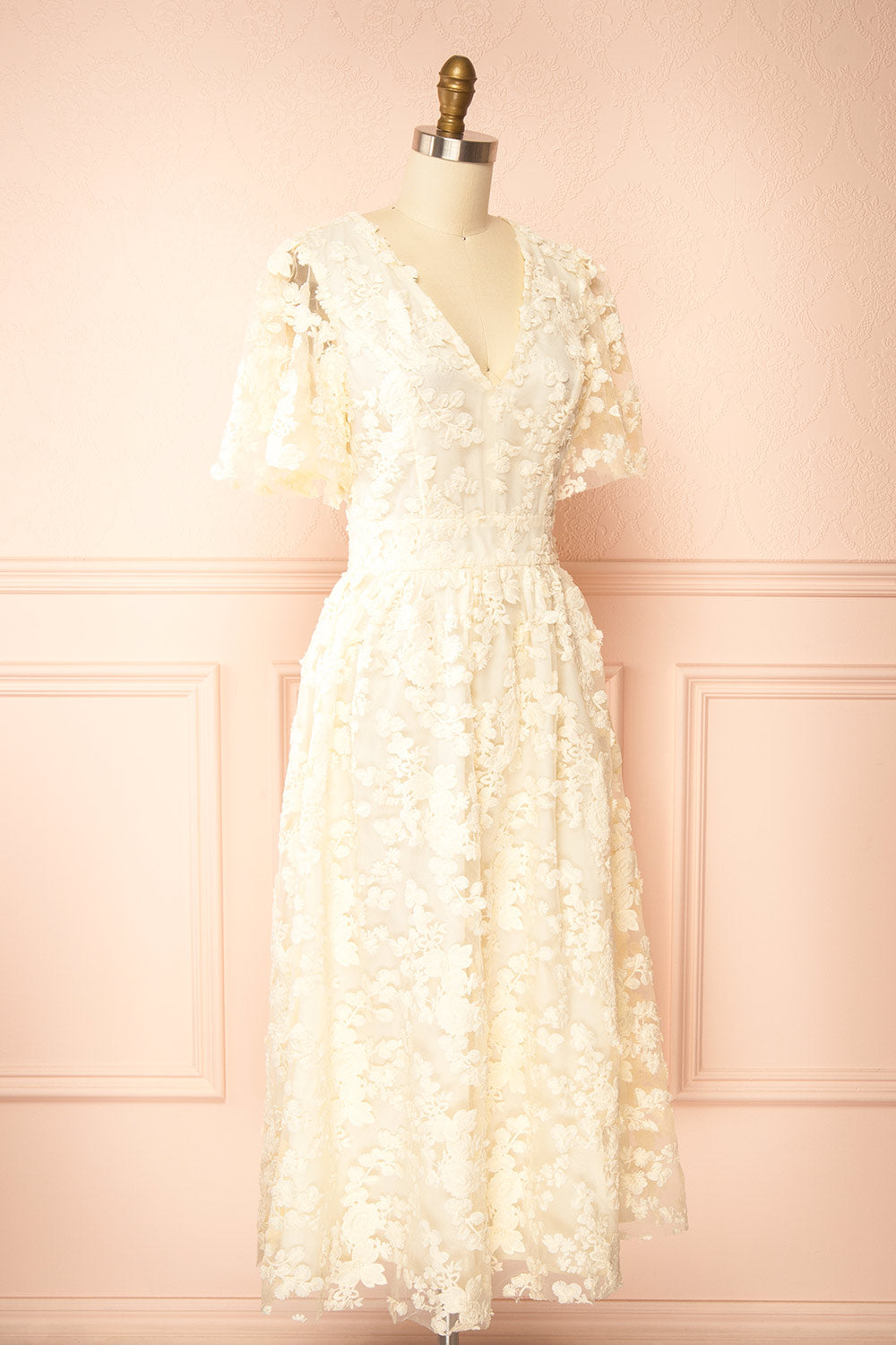 side view of a Mannequin wearing the Oukie Ivory Midi Floral Lace Dress from boutique 1861