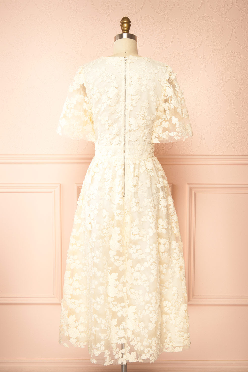 back view of a Mannequin wearing the Oukie Ivory Midi Floral Lace Dress from boutique 1861