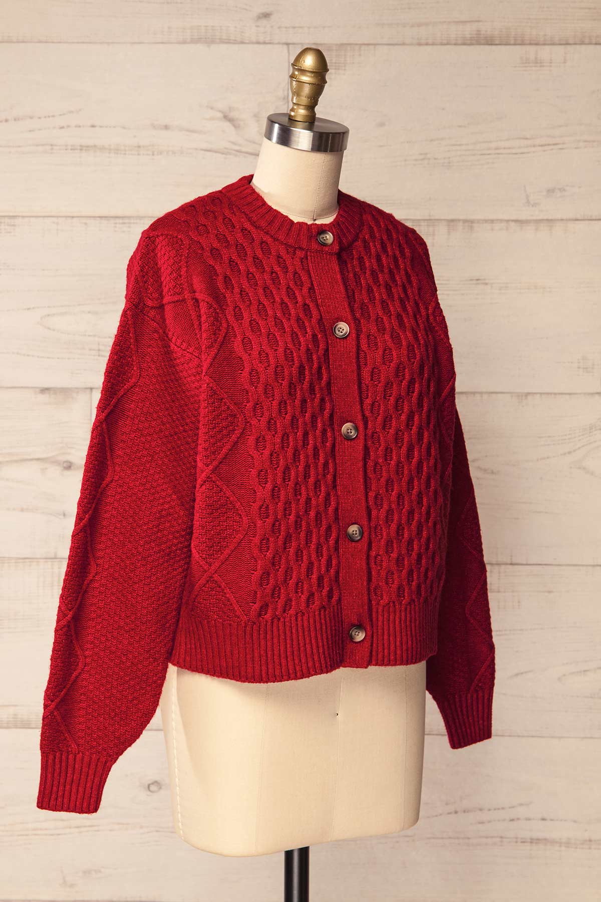 side view of Oyama Red Cable Knit Button-Front Cardigan at La petite garçonne
