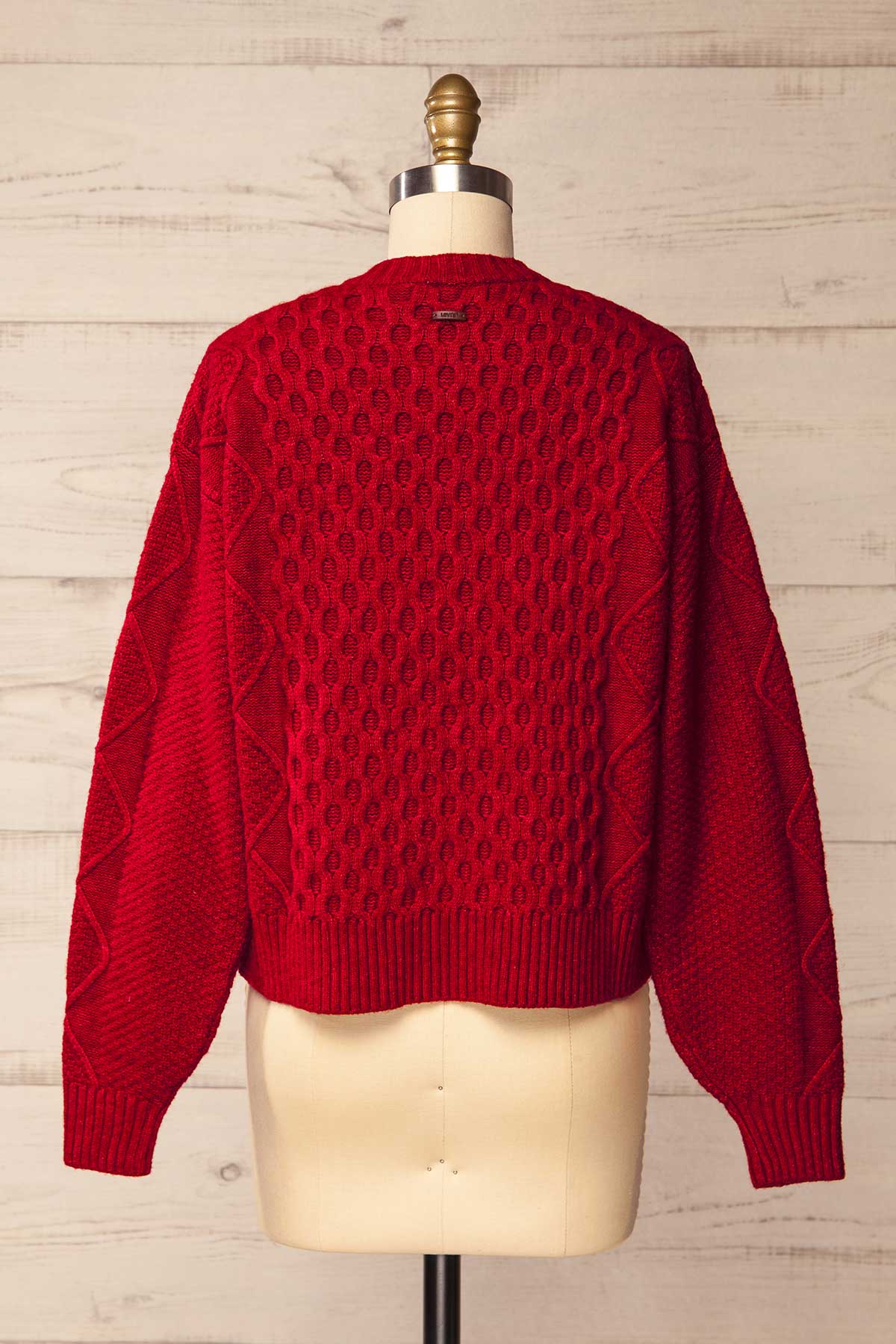 back view of Oyama Red Cable Knit Button-Front Cardigan at La petite garçonne