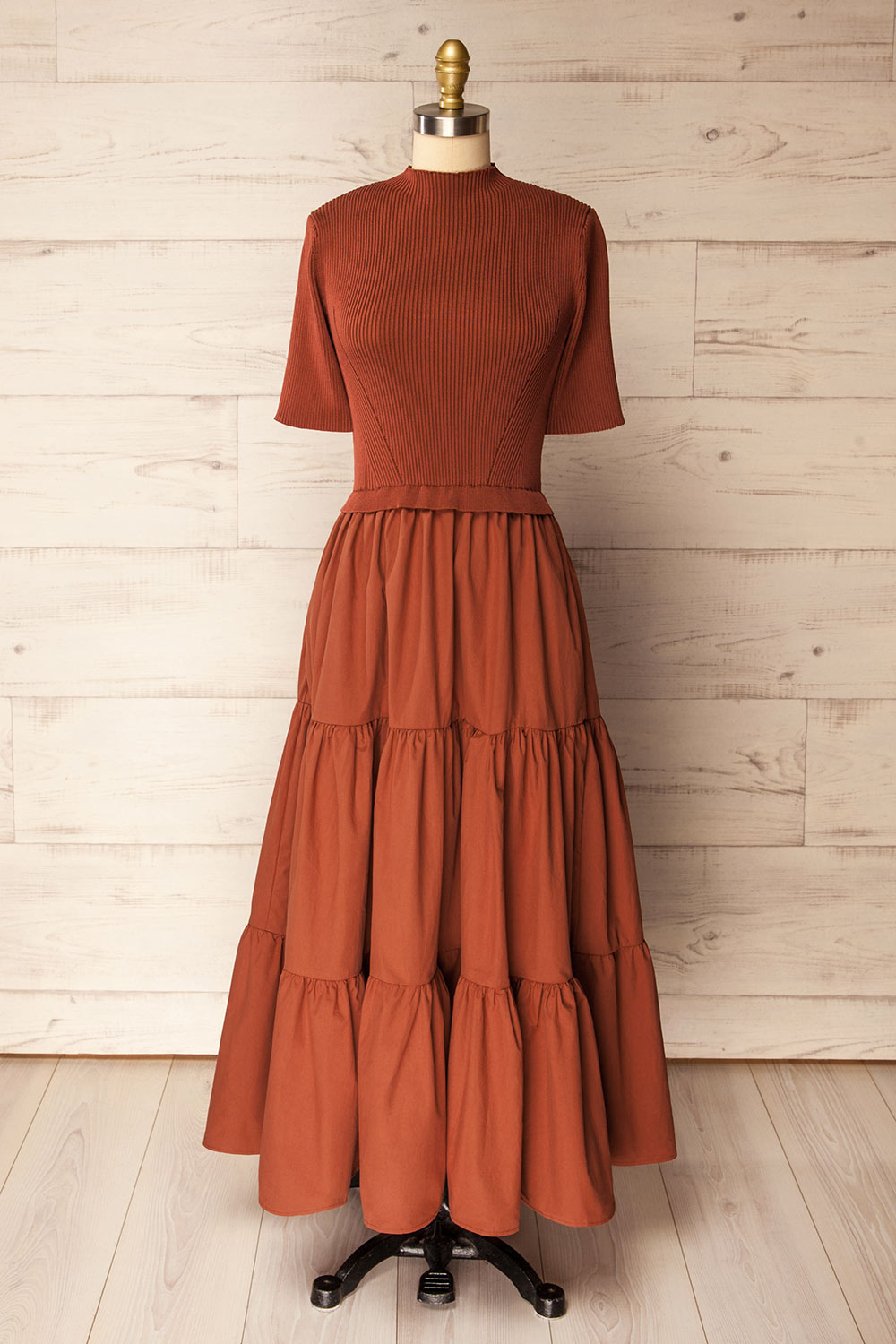 front view of a mannequin wearing the Penrith Rust Mock Neck Midi Dress from boutique 1861