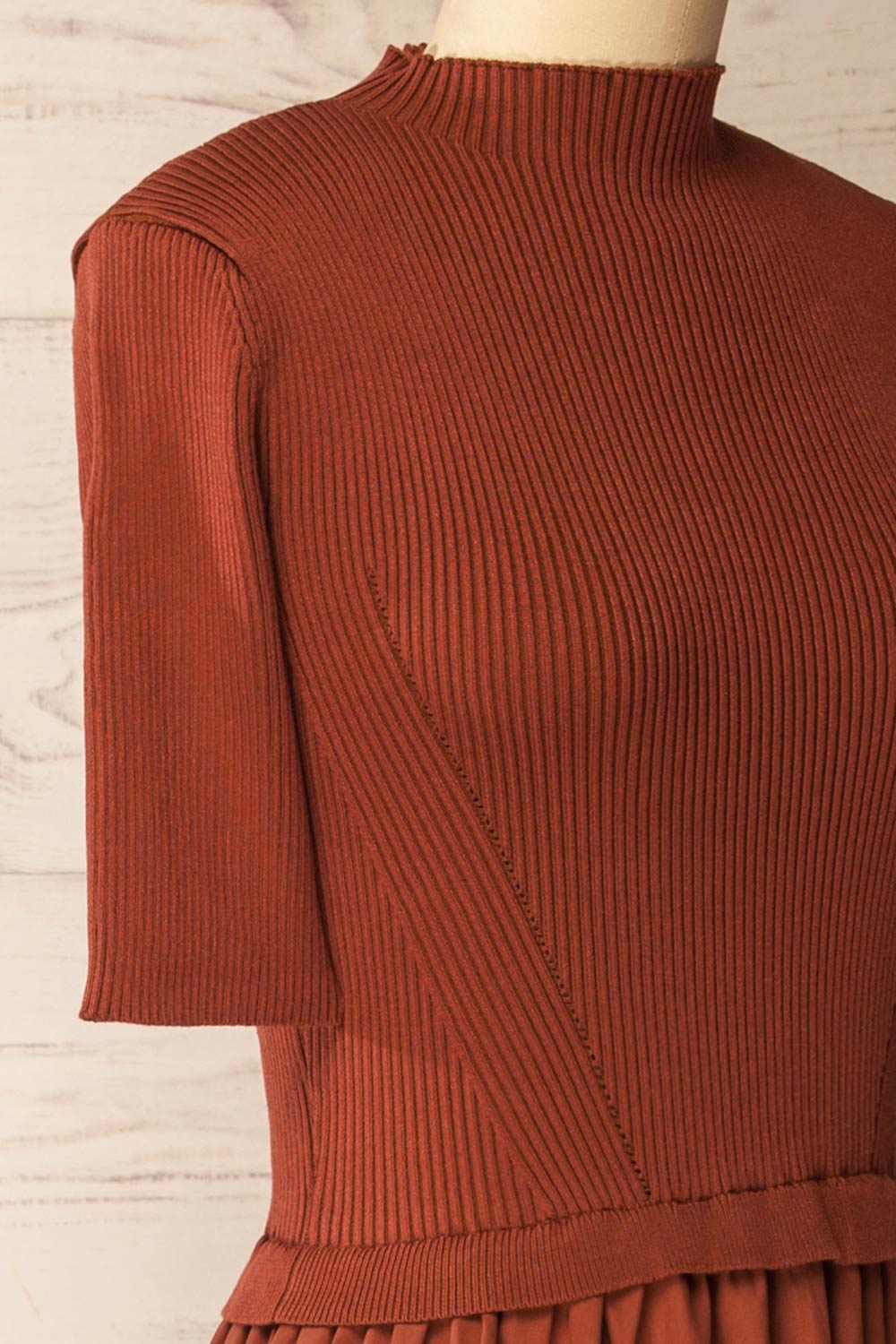 side of a mannequin wearing the Penrith Rust Mock Neck Midi Dress from boutique 1861