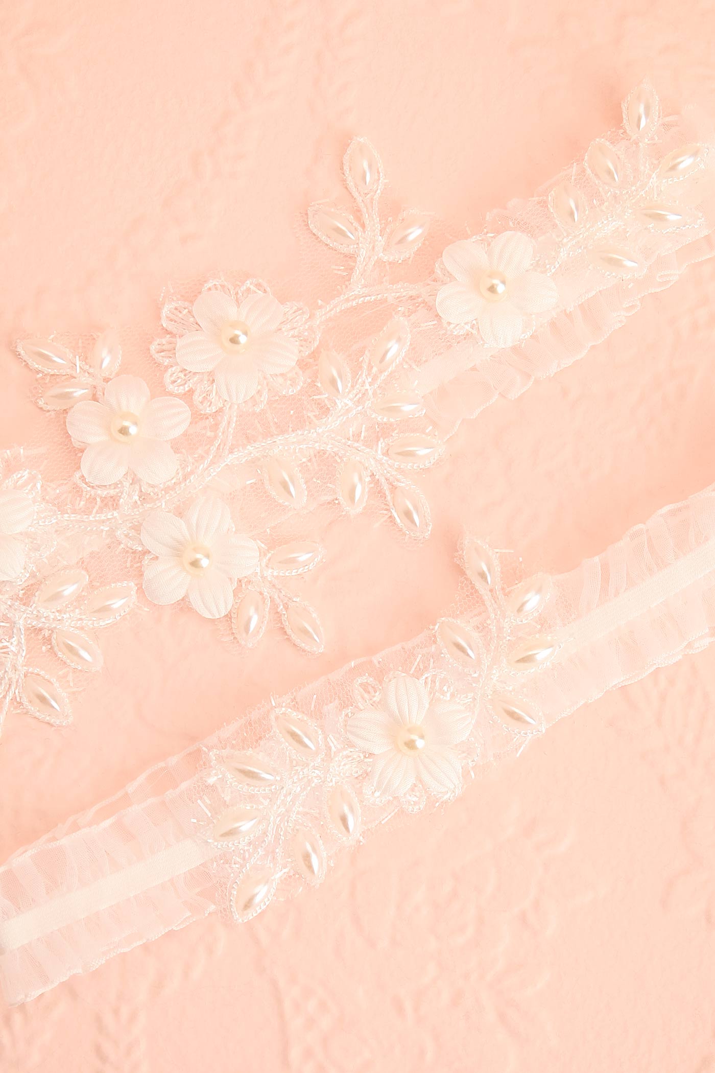 Close-up Starling Bridal Garter Set with White Floral Lace and Pearls at boudoir 1861
