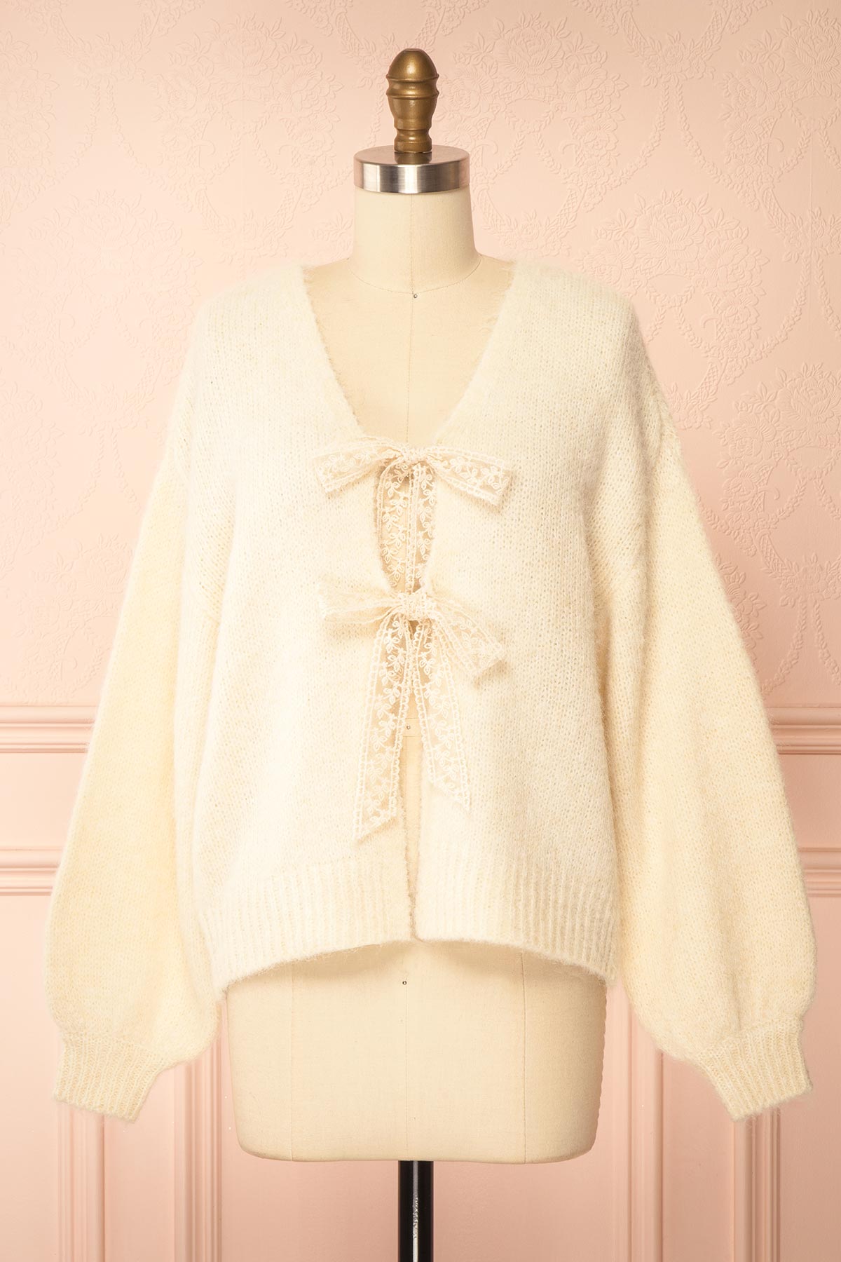 front view of Tsubaki Beige Knit V-Neck Cardigan Sweater with Lace Bows at Boutique 1861