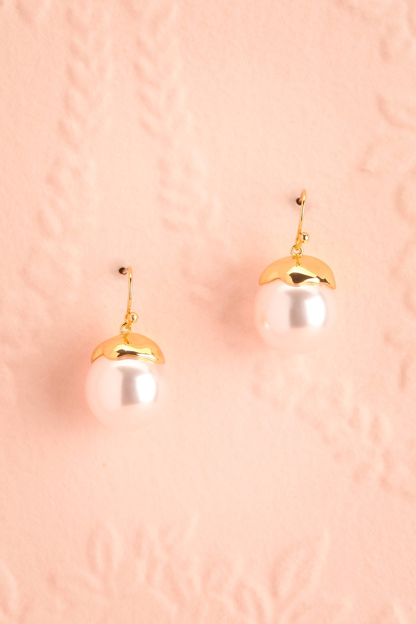Close-up of Ultraviolet Gold-Tone Pearl Drop Earrings at boutique 1861