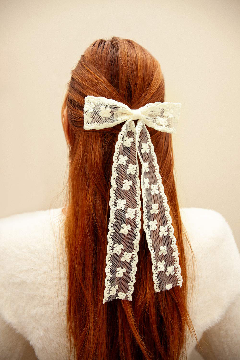 woman wearing Wednesday Ivory Lacy Bow Hair Clip from Boutique 1861