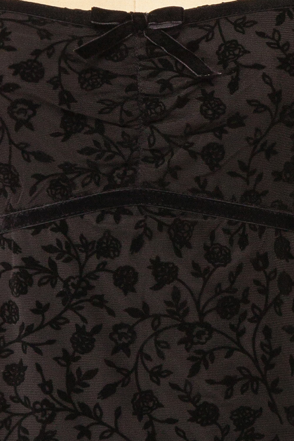 fabric of a mannequin wearing a Zoeline Short Long-Sleeved Black Dress from boutique 1861