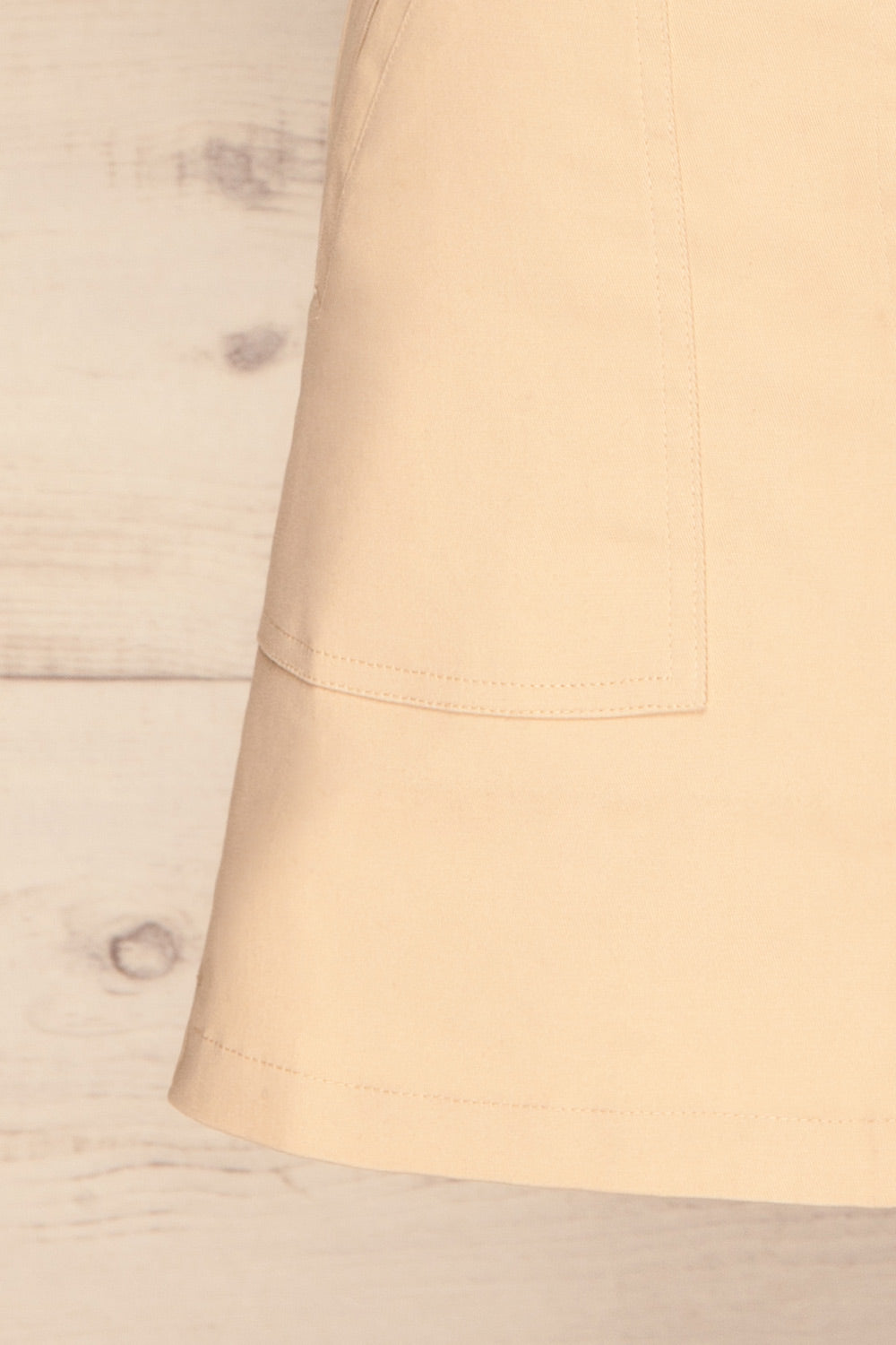Alijo Beige Button-Up Mini Skirt with Pockets | La Petite Garçonne bottom close-up