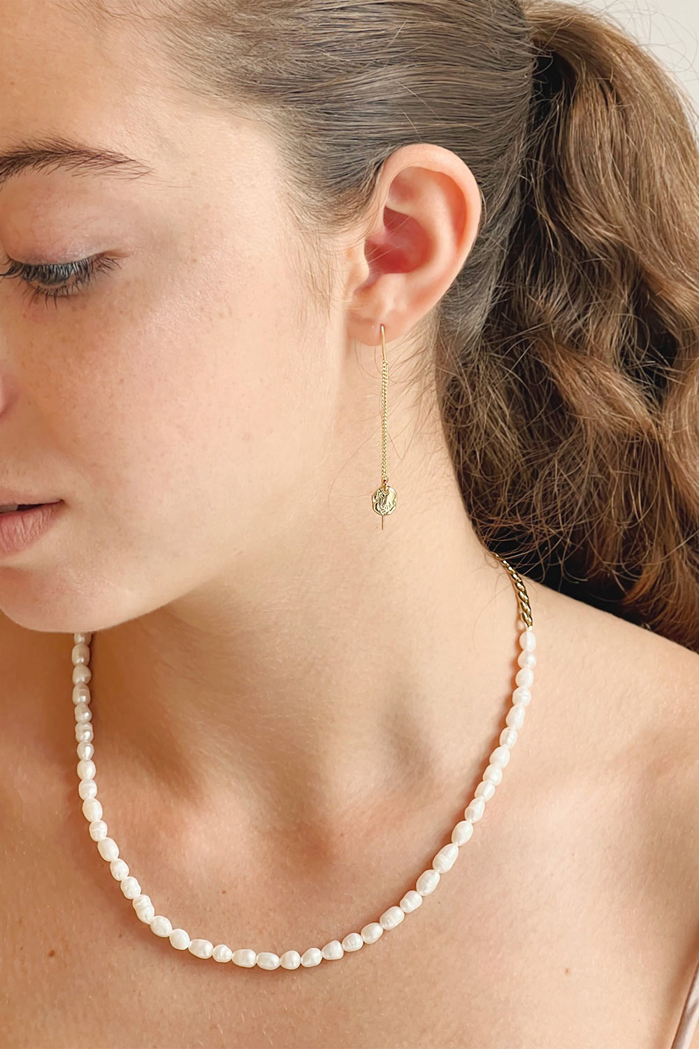 Ambergris Gold Thread Through Earrings w/ Engraved Handcrafted Shield on model