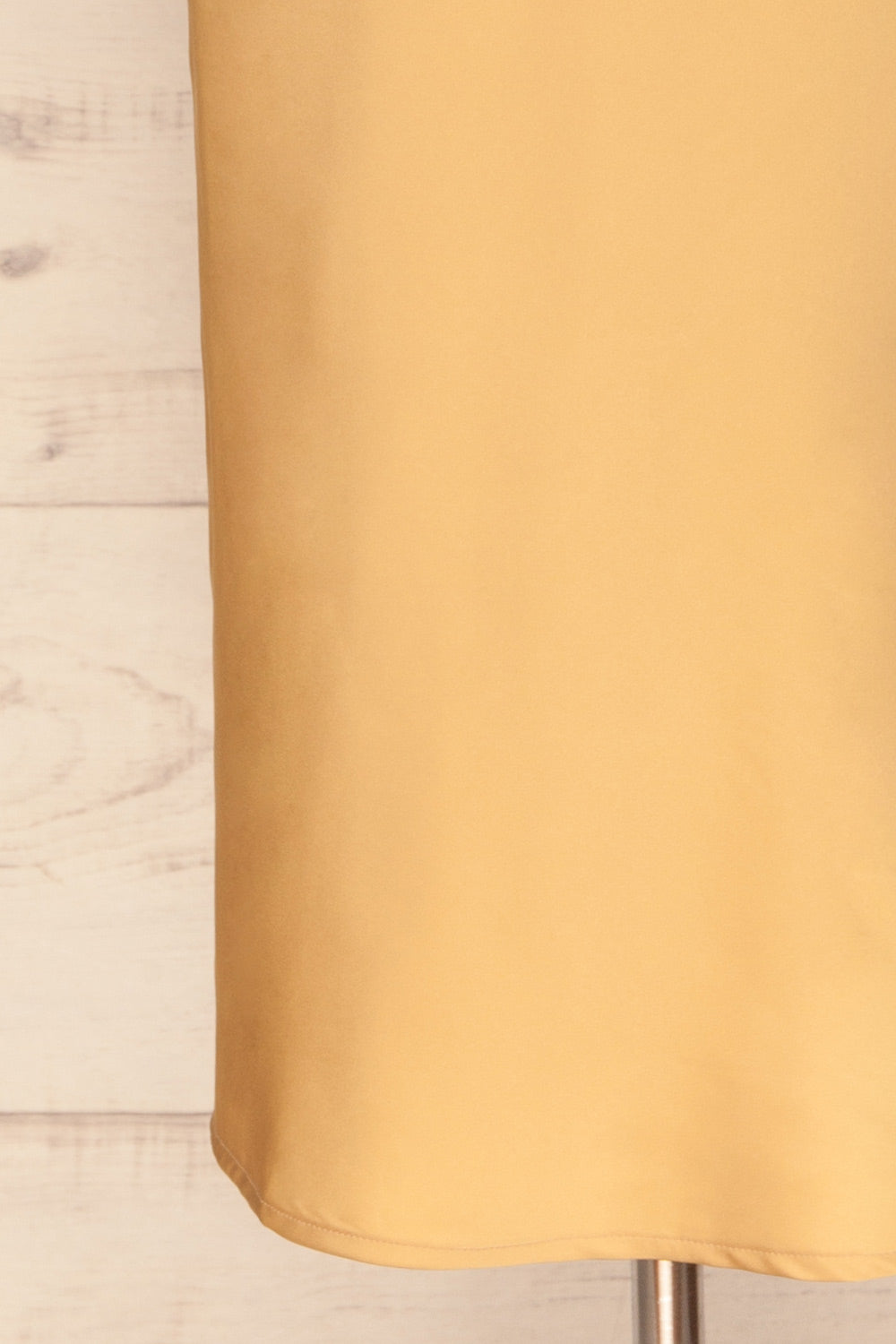 Enea Champagne Yellow Satin Midi Slip Dress | La Petite Garçonne bottom close-up
