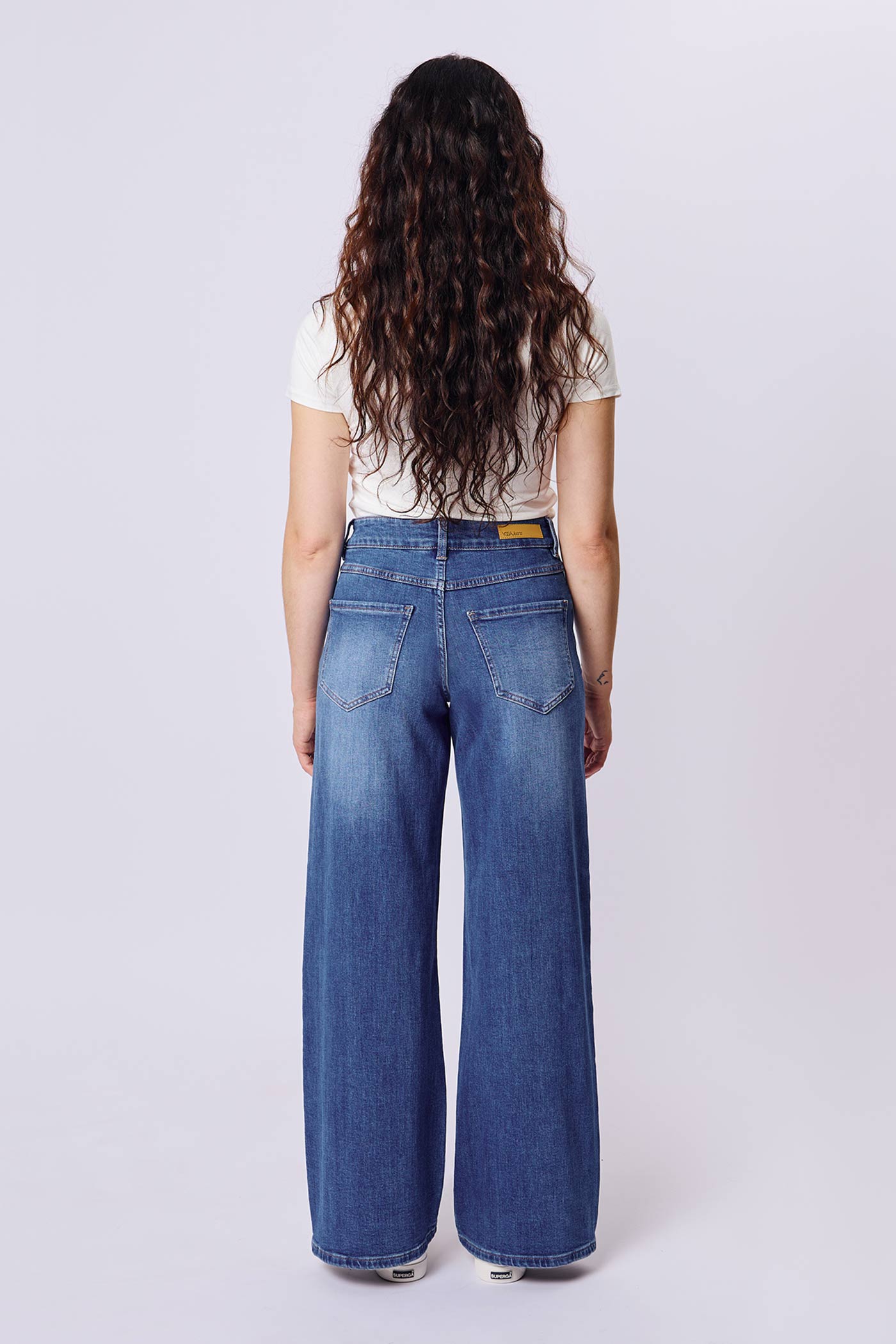 back of a woman wearing Aurora Jeans Blue High-Waisted Wide-Leg Jeans by Dailystory from La petite garçonne
