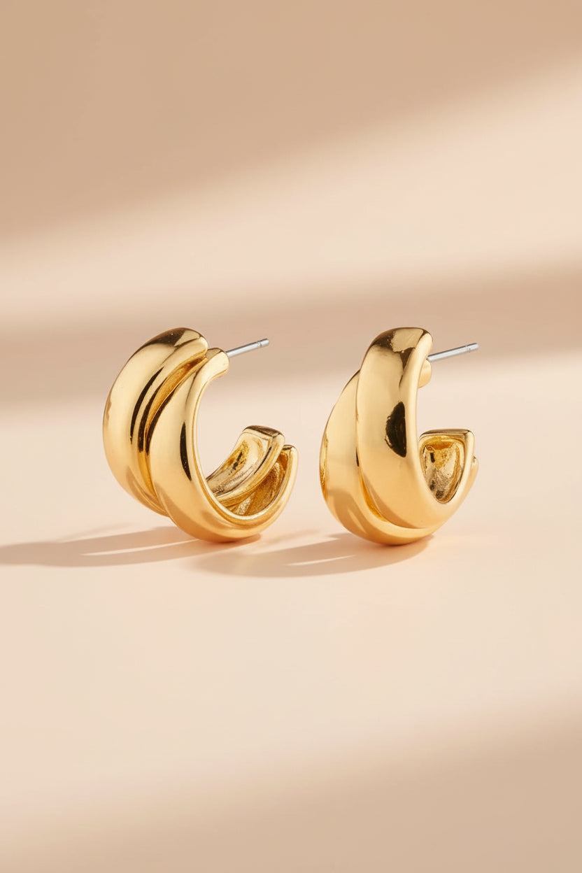 Gold hoop earrings named Norit gold from Pilgrim on a white background