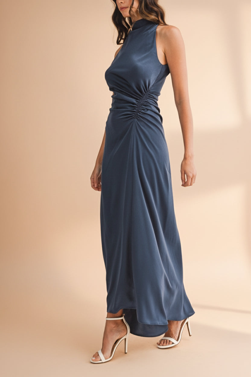 Woman in side-profile wearing the Alberta Navy Maxi Dress with a high neckline from Boutique 1861.