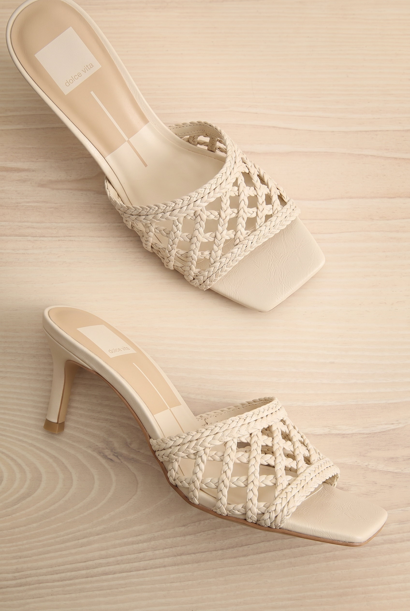 Pair of Dolce Vita Boween Ivory Braided Faux Leather Kitten Heel Mules from la petite garçonne.