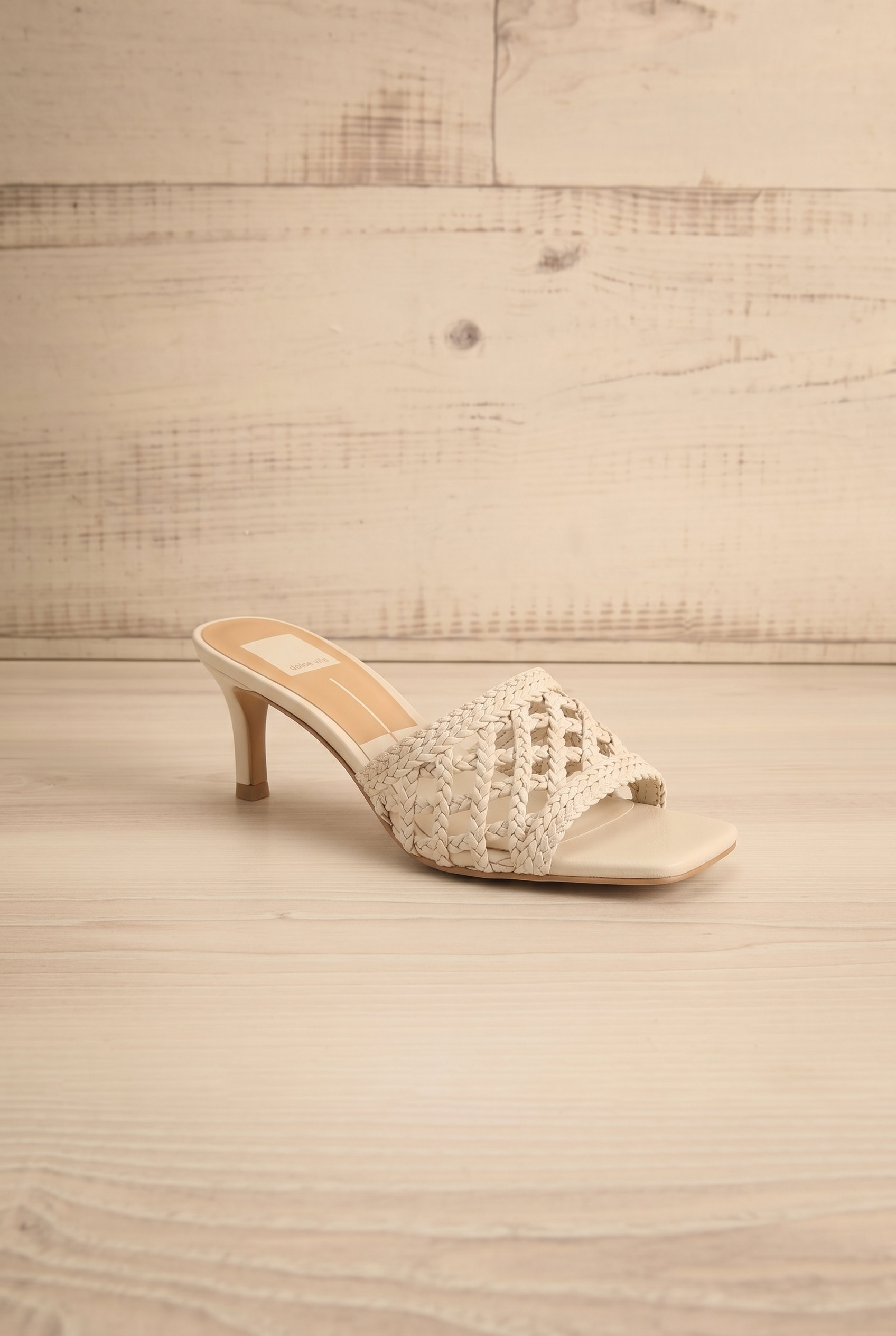 sideview of Dolce Vita Boween Ivory Braided Faux Leather Kitten Heel Mules from la petite garçonne.