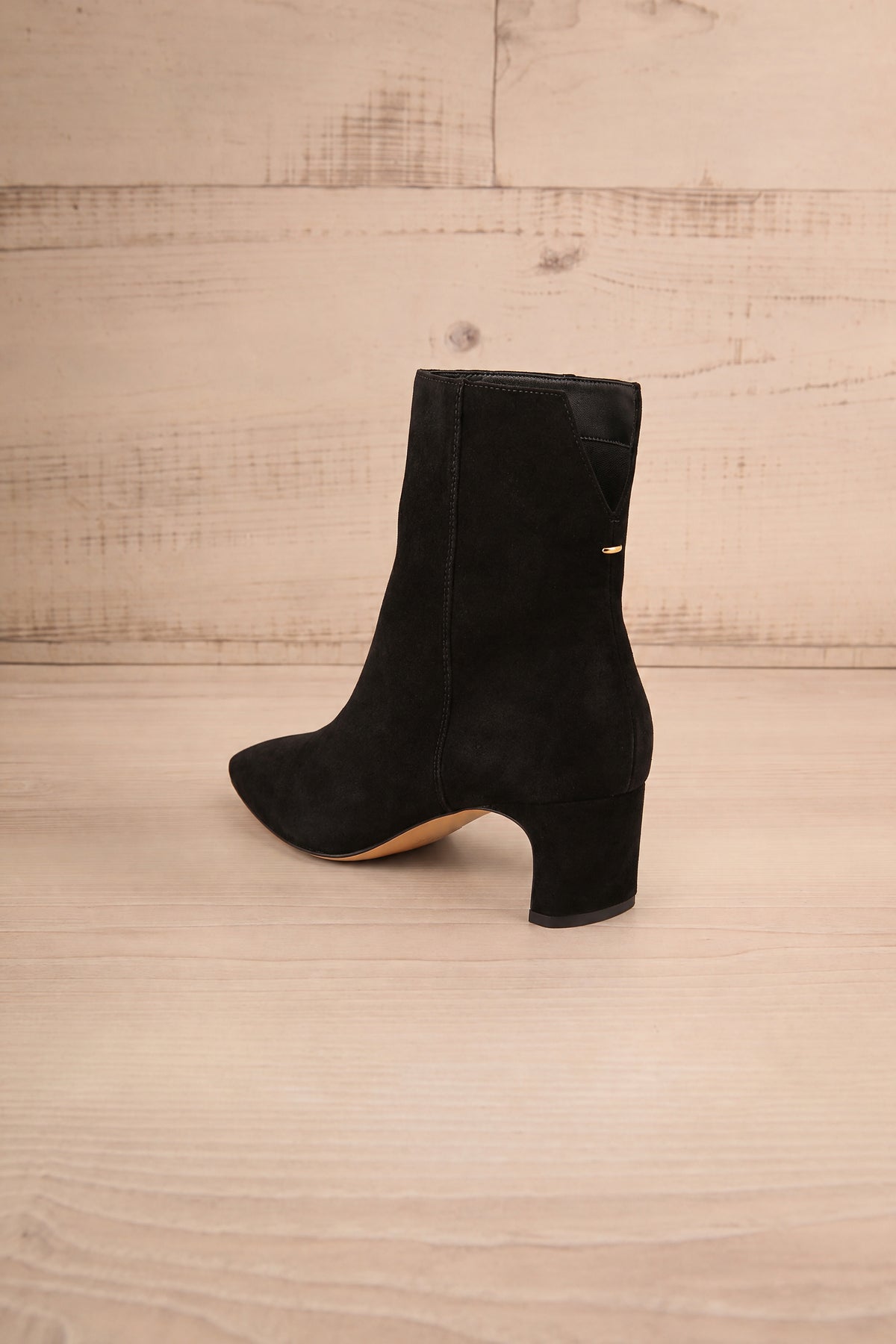 Back view of a single pointed-toe Bennet Black  Leather Ankle Boot from Dolce Vita at la petite garçonne in Montreal