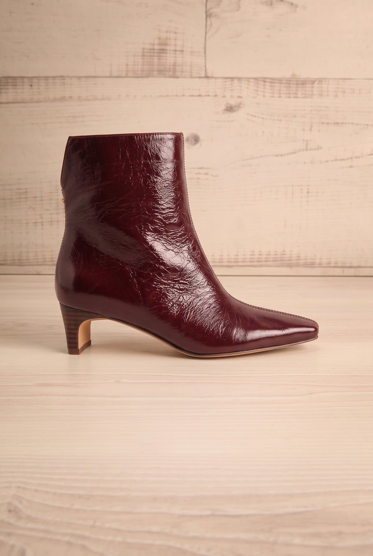 Side view of a single pointed-toe Bennet Burgundy  Leather Ankle Boot from Dolce Vita at la petite garçonne in Montreal