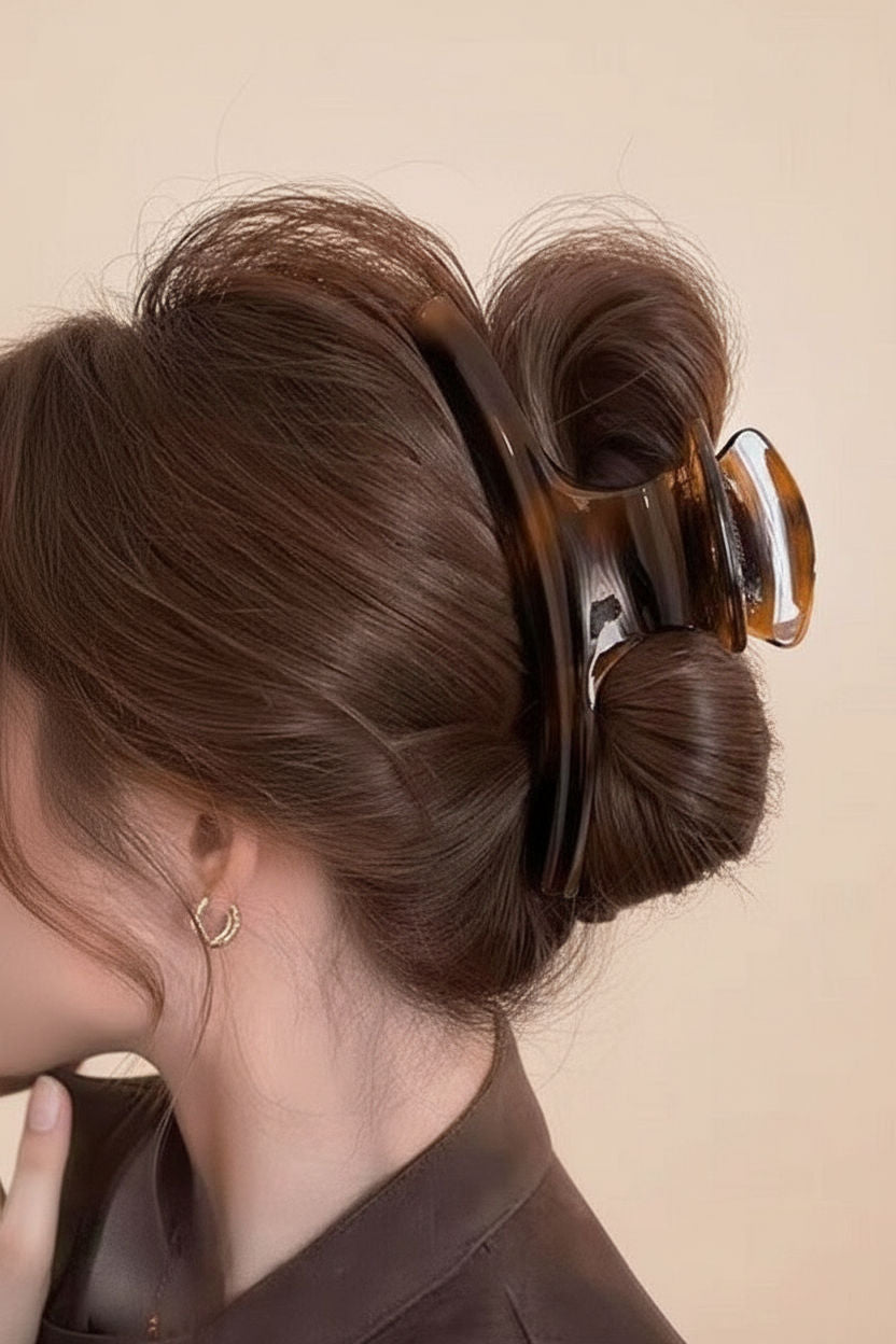 Woman with styled hair using a large hair clip named Biscuit Tortoise a beige background