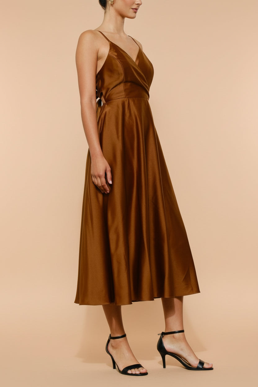 Side view of a woman wearing the Caryanne Brown Tie-Back Satin Dress from Boutique 1861