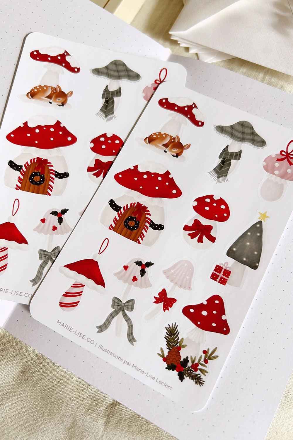 Two sheets of Christmas-themed stickers with various mushroom designs from Marie Lise illustration