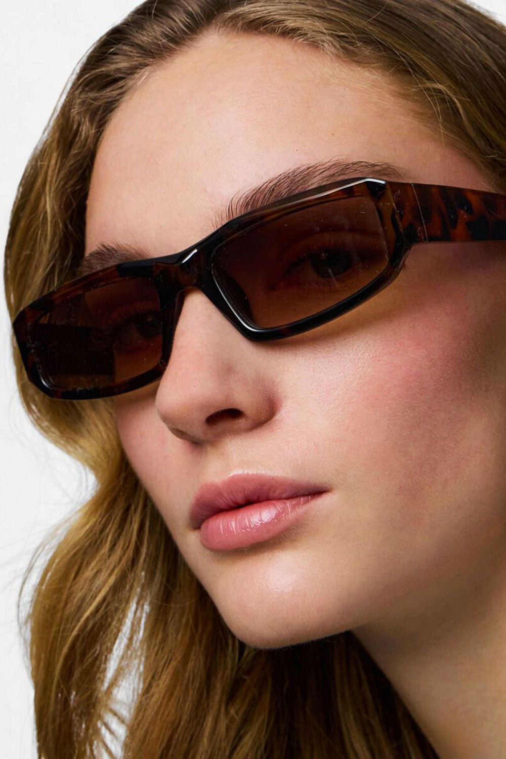 close-up of a woman wearing Atul Brown Tortoise Shell Rectangular Sunglasses from La petite garçonne 