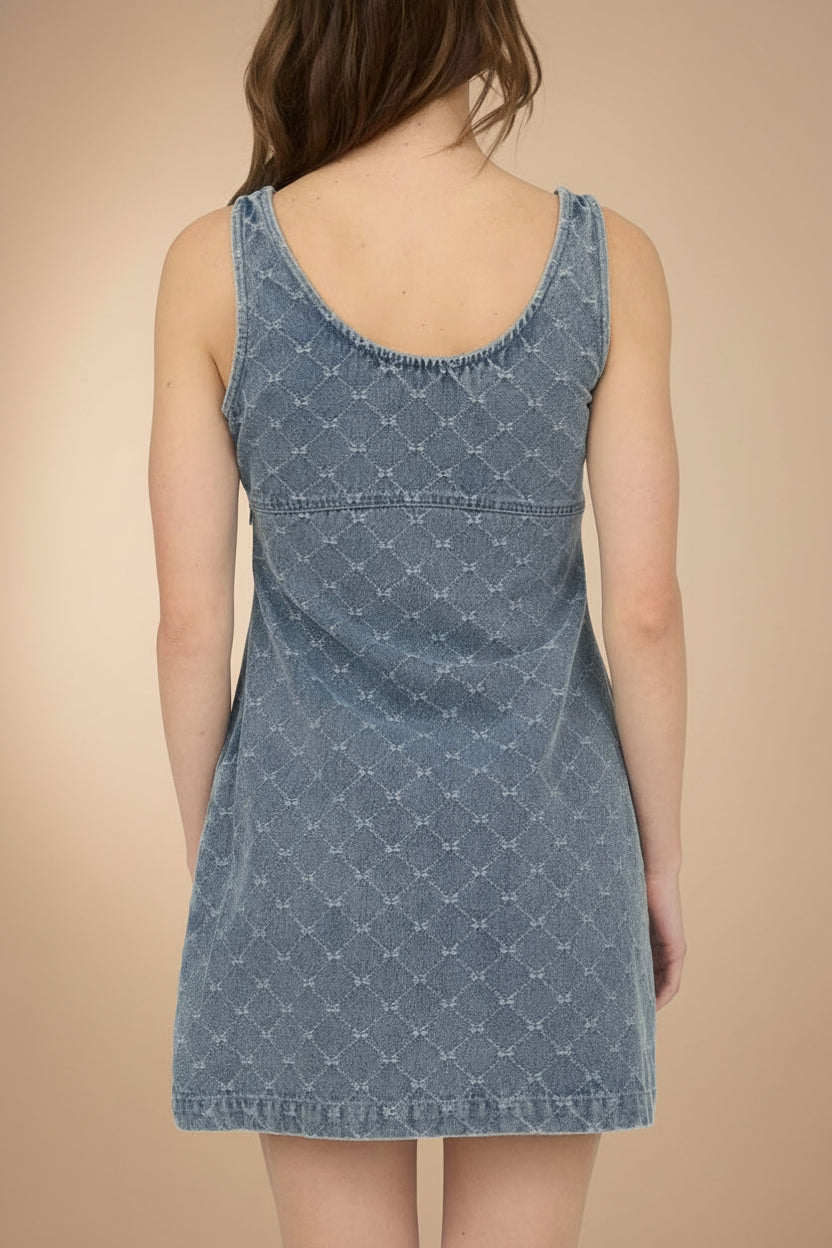 Woman wearing Chisapani Blue Denim Mini Dress with Bow Pattern from La petite garçonne backview