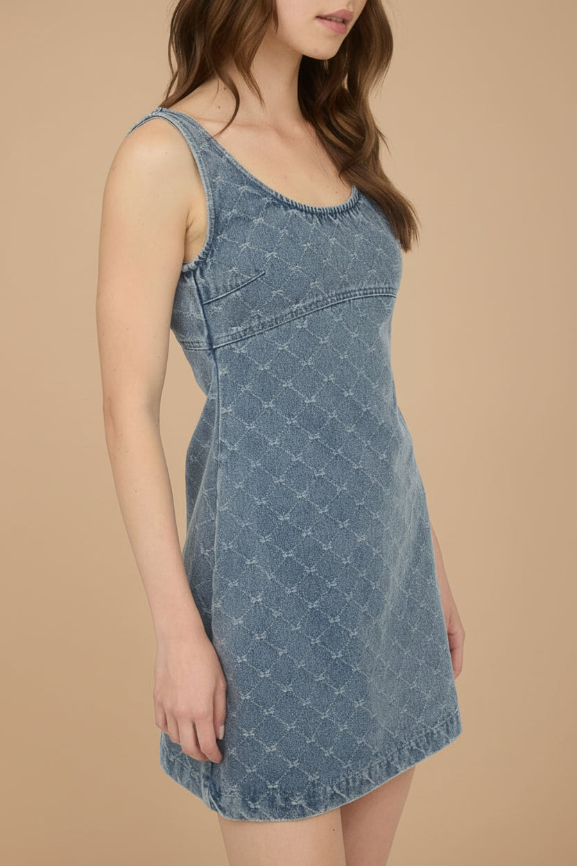 Woman wearing Chisapani Blue Denim Mini Dress with Bow Pattern from La petite garçonne sideview