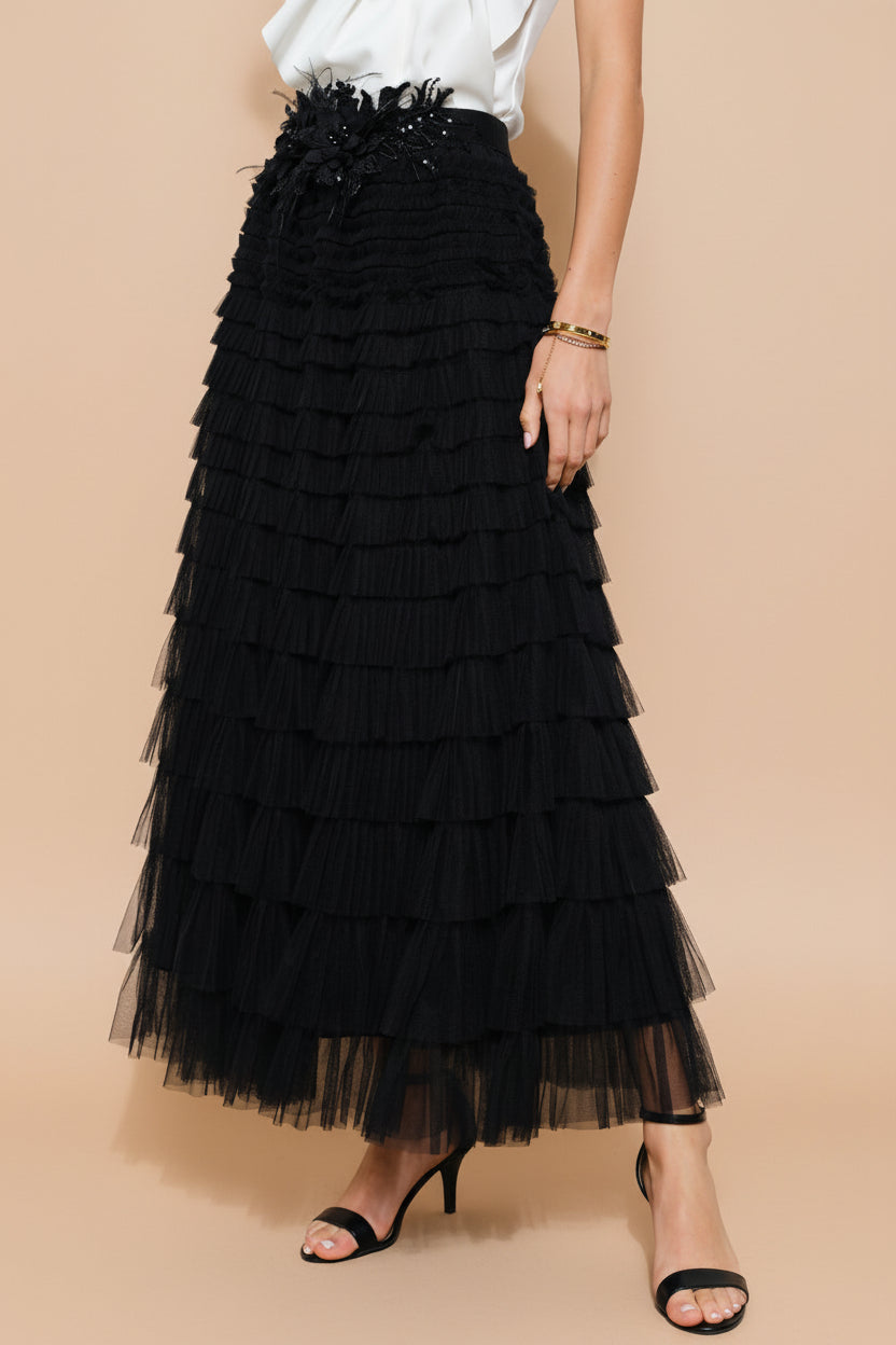 side close-up of a woman wearing Christabel Black Ruffled Maxi Skirt with 3D Flowers from Boutique 1861