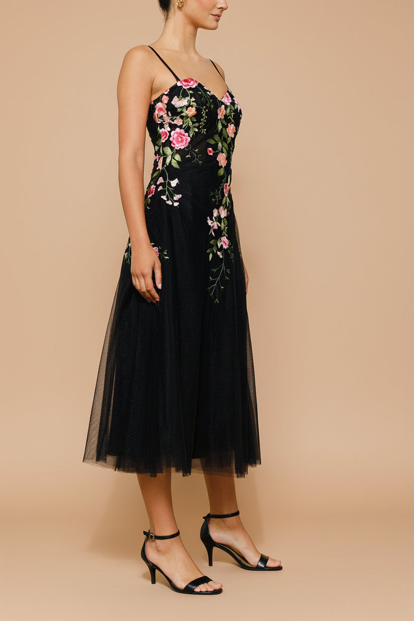 side view of a woman wearing Claree Black Corset Tulle Midi Dress with Floral Embroidery from Boutique 1861