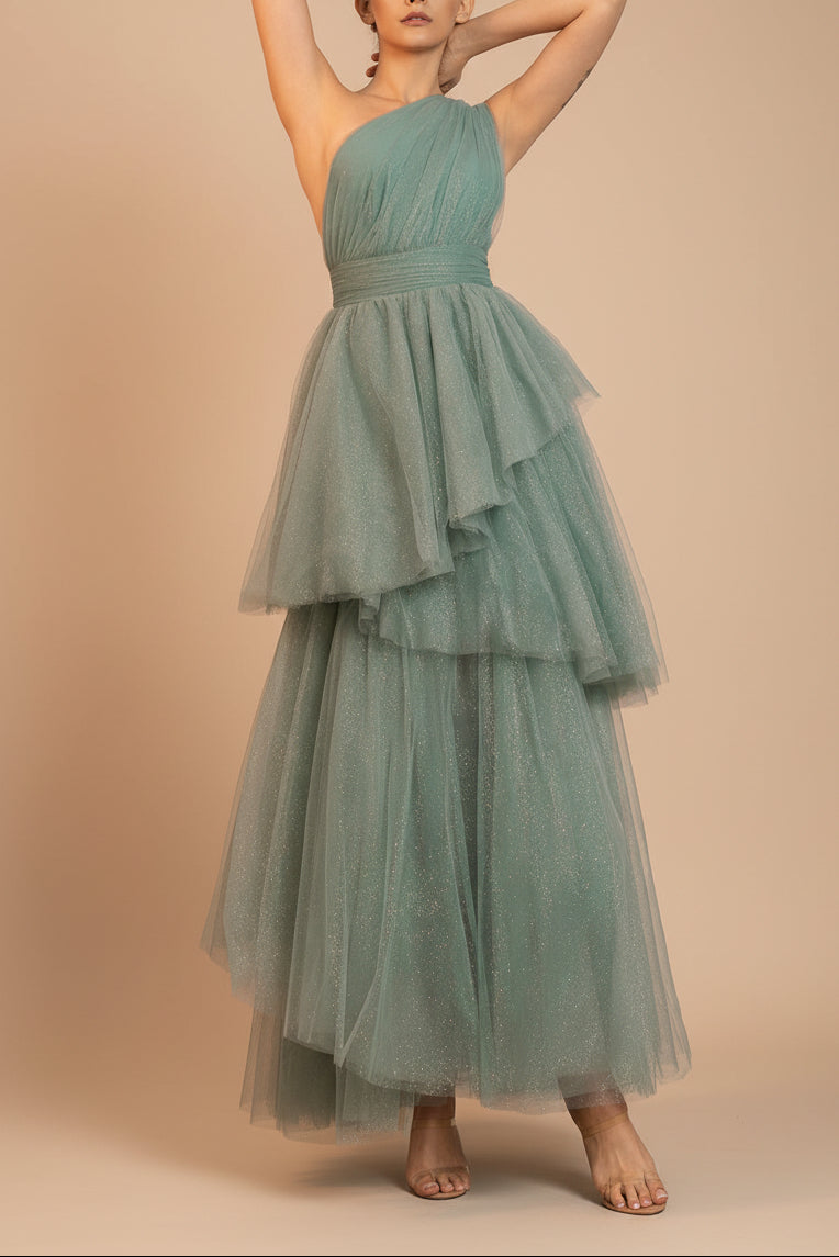 front of a woman wearing Cody Teal Maxi One Shoulder Dress with Glitters from  Boutique 1861