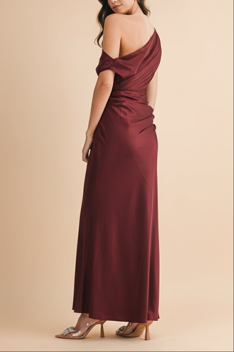 Backview of a Woman wearing a Colleen Burgundy Asymmetrical Satin Dress from boutique 1861