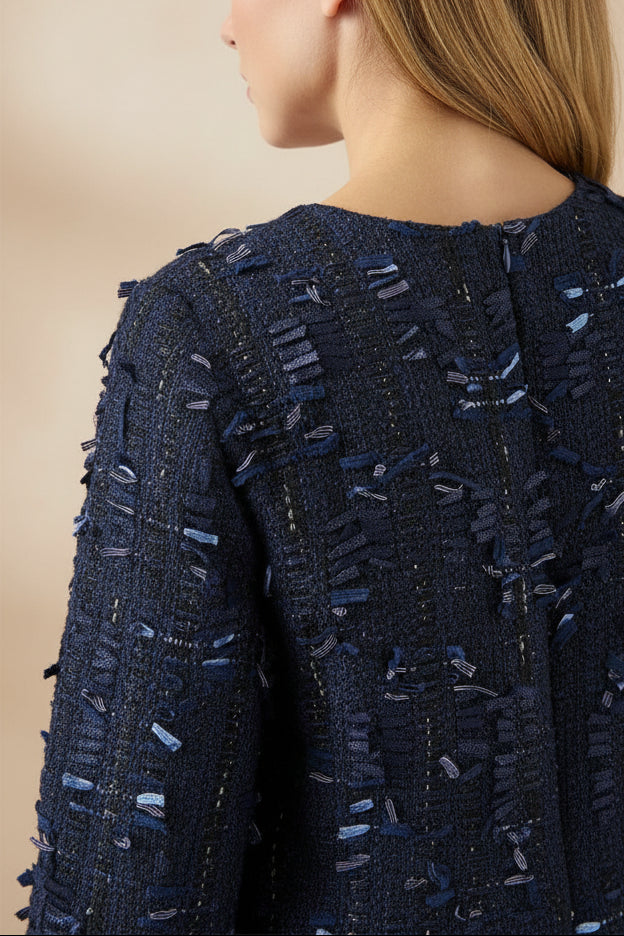 back close-up of a woman wearing Coralyne Navy Tweed V-Neck Mini Dress from Boutique 1861